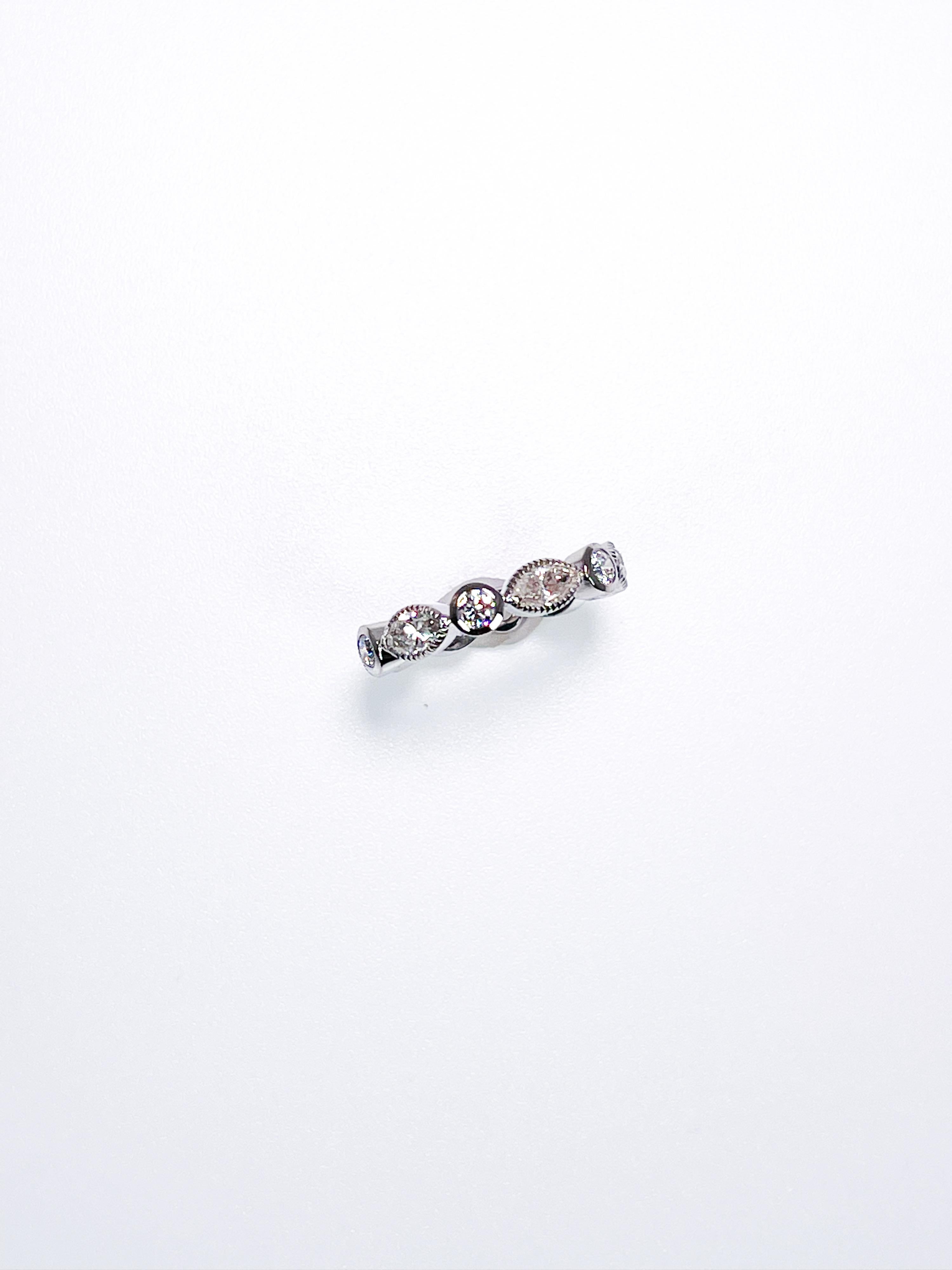 Diamond eternity ring made with marquise and round diamonds in platinum. The ring has hand engraving milgrain details on the edges.
GRAM WEIGHT: 5.17gr
METAL: platinum

NATURAL DIAMOND(S)
Cut: Round Brilliant
Color: E-F 
Clarity: VS-SI 
Carat: