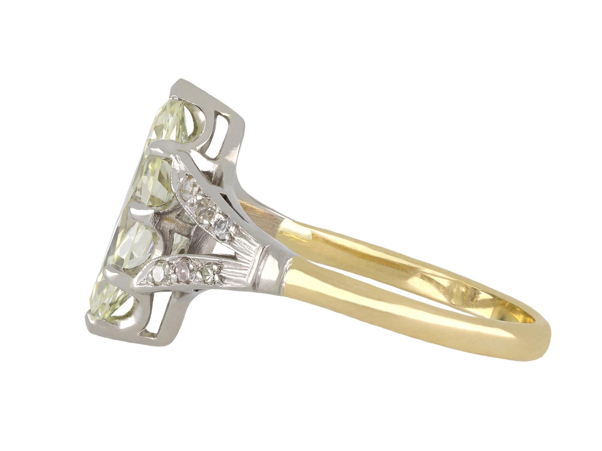 Marquise diamond flanked solitaire ring. Set to centre with a marquise shape old cut diamond, U-V range colour, VS1 clarity, with a weight of 2.20 carats in an open back claw setting, flanked with twelve round eight cut diamonds in open back grain
