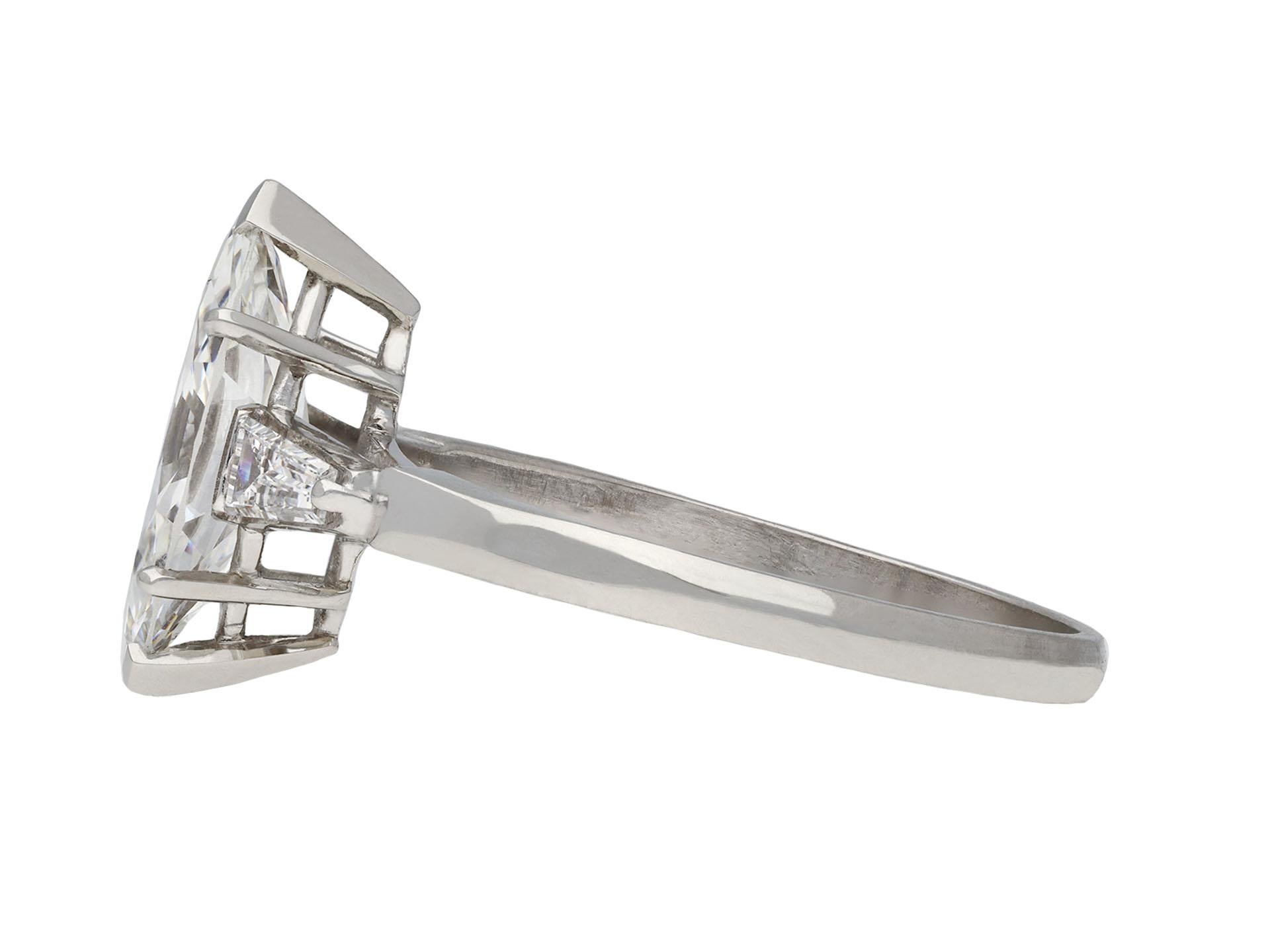 Marquise diamond flanked solitaire ring. Set to centre with a marquise shape transitional cut diamond, F colour, VS2 clarity, with a weight of 1.74 carats, in an open back claw setting, flanked by two tapered baguette cut diamonds in open back claw