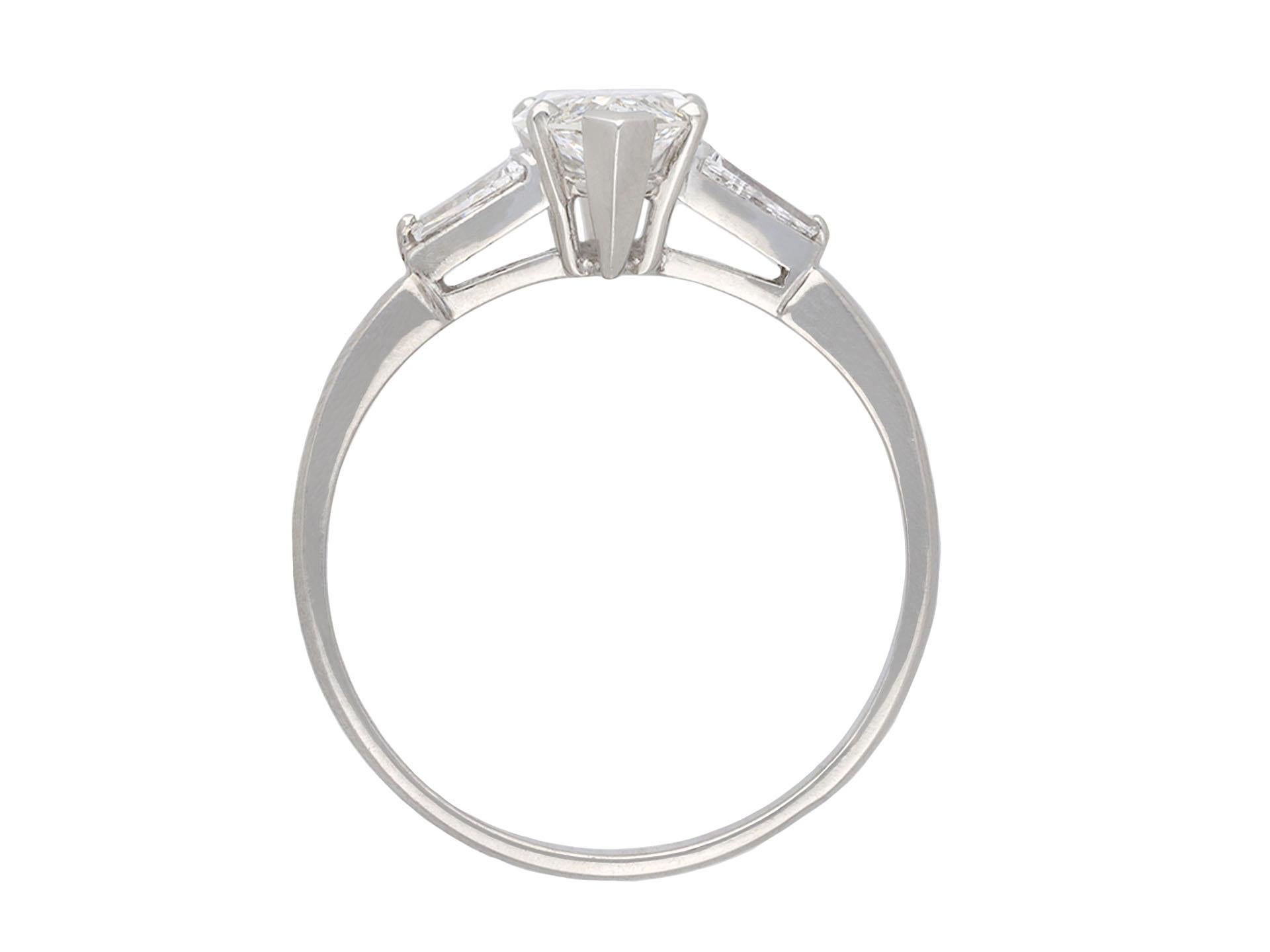 Marquise Cut Marquise diamond flanked solitaire ring, circa 1950. For Sale