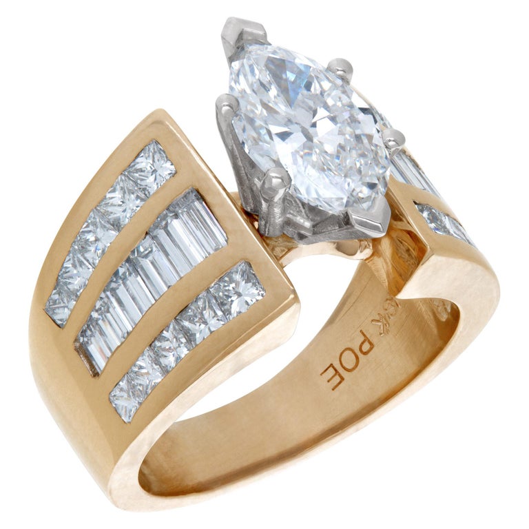 GIA report certified marquise cut diamond 1.52 carat (F Color, SI2 clarity) ring in 14k and platinum with approximately 2 carats in channel set baguette and princess cut side diamonds. Size 5. This GIA report certified ring is currently size 5 and