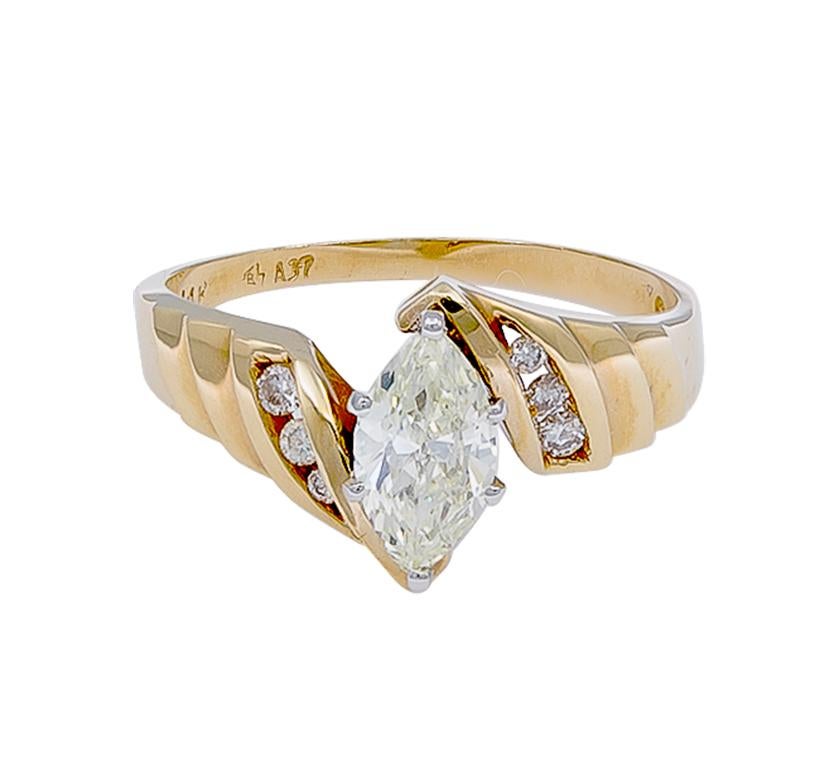 One marquise diamond ring featuring an approximate of .70 carats.  Surrounded by 3 round brilliant cut diamonds on each side. Set in 14K yellow gold material. Classic!

Color: K ; Clarity: SI1. 26 Mq 
Stamped 14k A37

Ring Size: 6.75 
(can be
