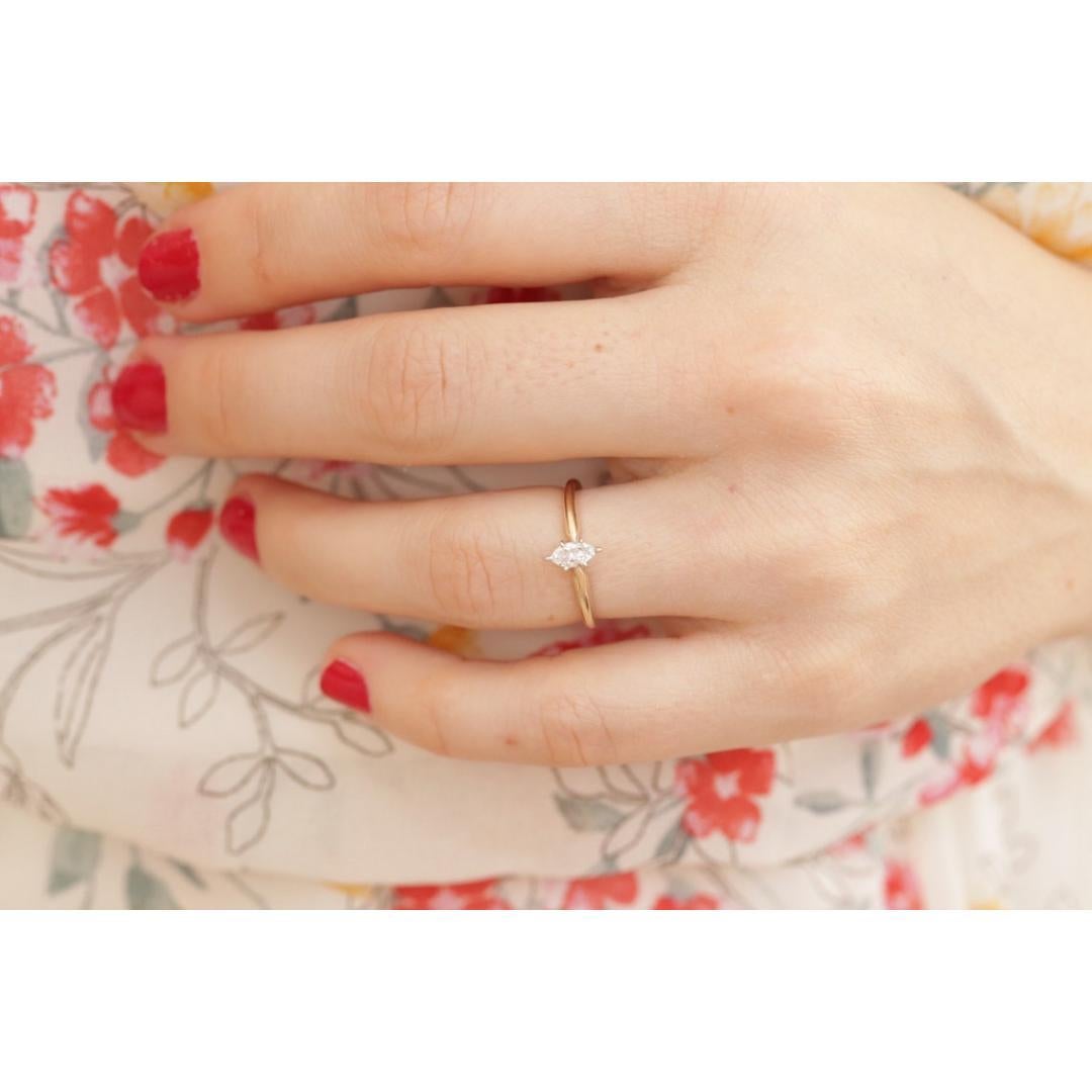 Vintage from the 1990s
Materials: Rose gold
Gemstone: Diamond
Gem Color: Colorless
Band Color: Yellow

Style: Art Nouveau

Petite engagement ring. Marquise Diamond solitaire prong set.

Condition: Band has tiny scratches. Has not been
