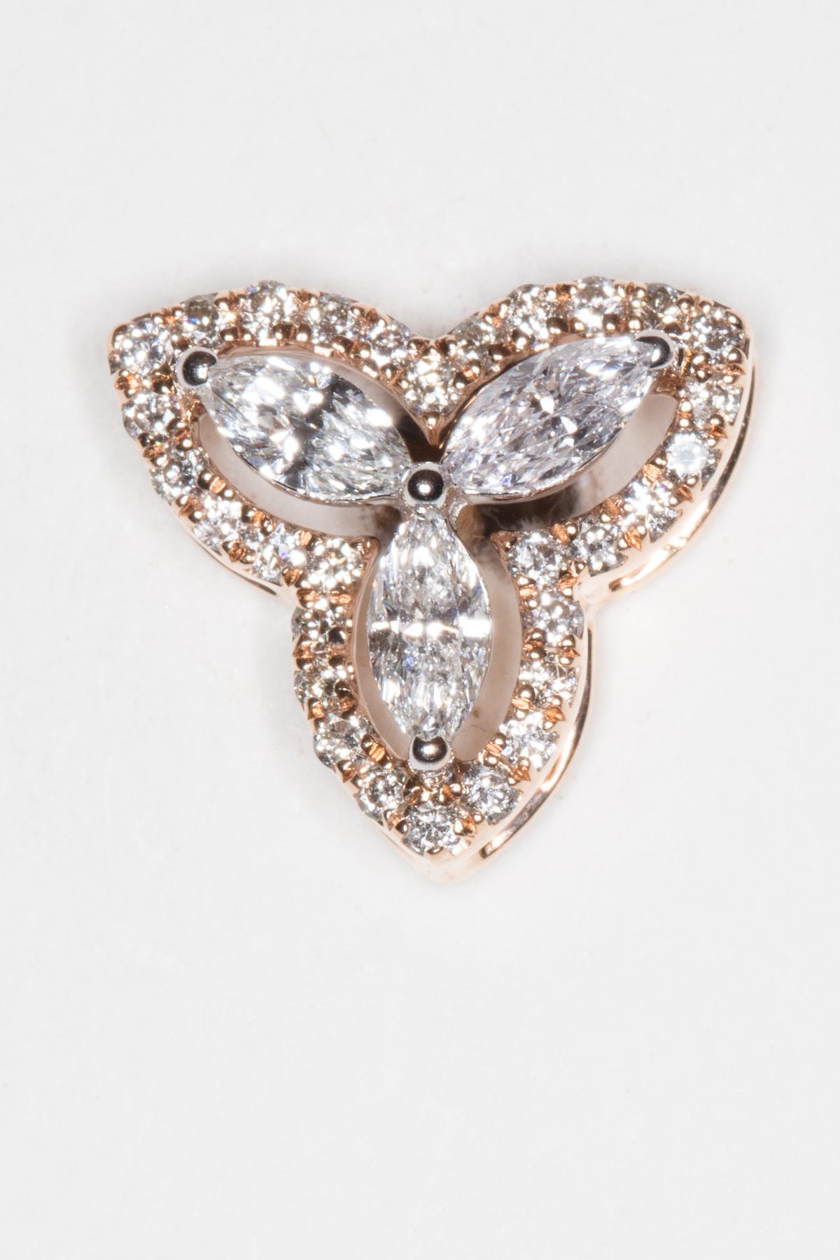 A cluster of three marquise cut diamonds bordered with pave`-set diamonds in an 18K rose gold.  Great color and clarity to the diamonds.  Carat weight unknown.  For pierced ears with screw backs.