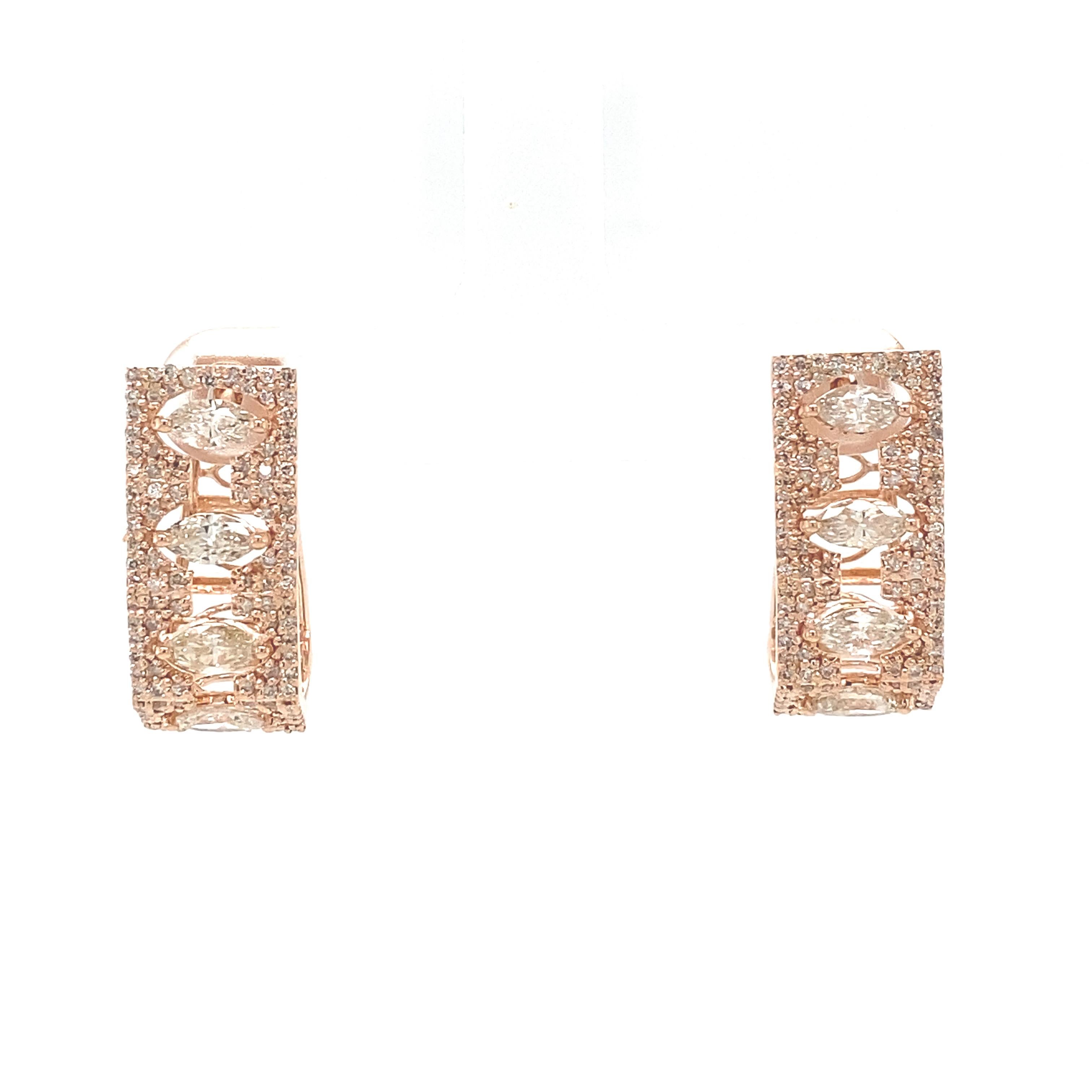 A pair of sophisticated bar plug earrings, finely crafted in 18K solid gold. These earrings feature a stunning array of marquise-cut diamonds, meticulously arranged in a vertical line to create a sleek and modern bar silhouette. Surrounding the