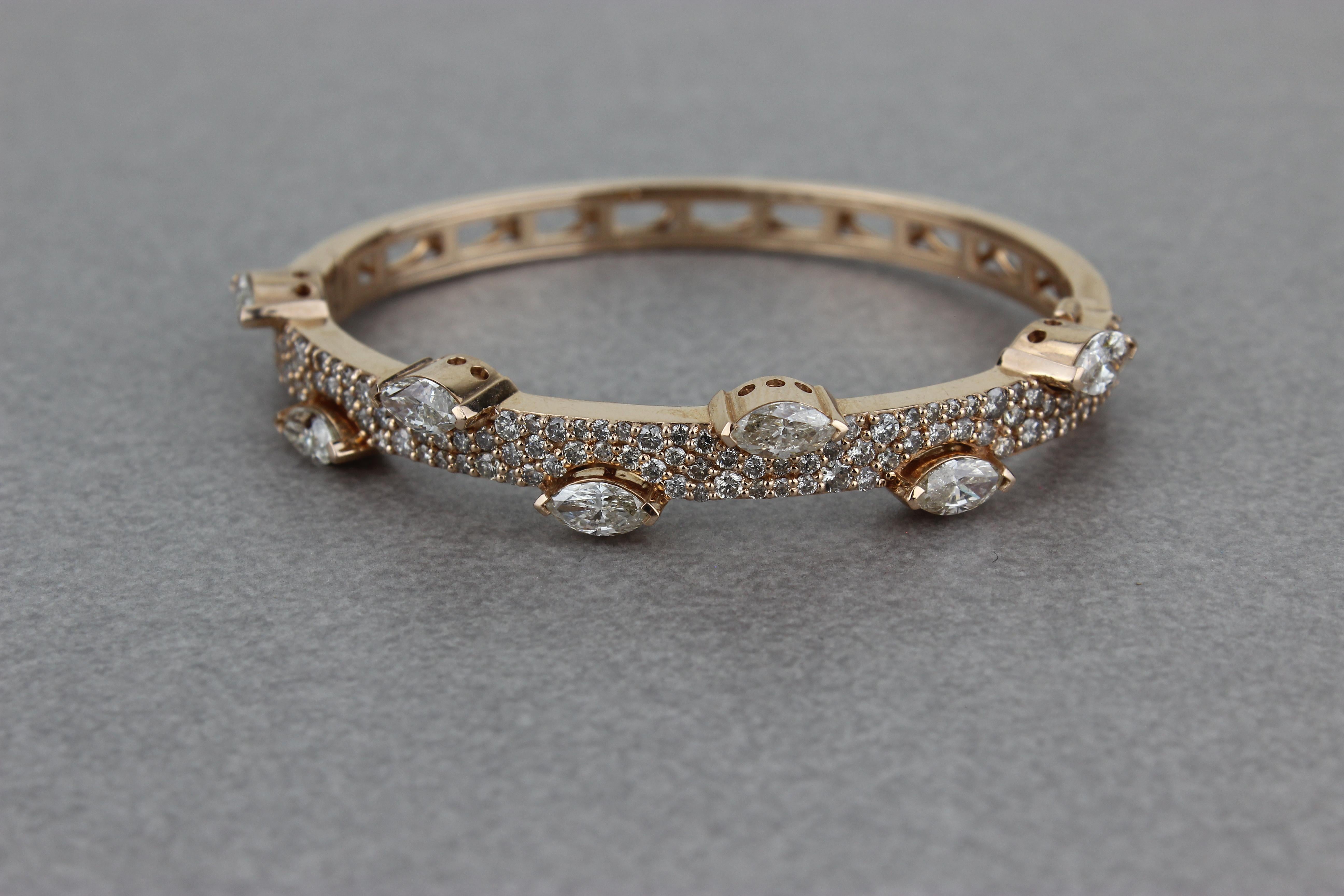 The Marquise Diamonds Half Bracelet is a luxurious and elegant jewelry piece with marquise-shaped diamonds set in solid 18k gold. The diamonds are arranged in a stunning design that showcases their unique shape and sparkle, with the marquise