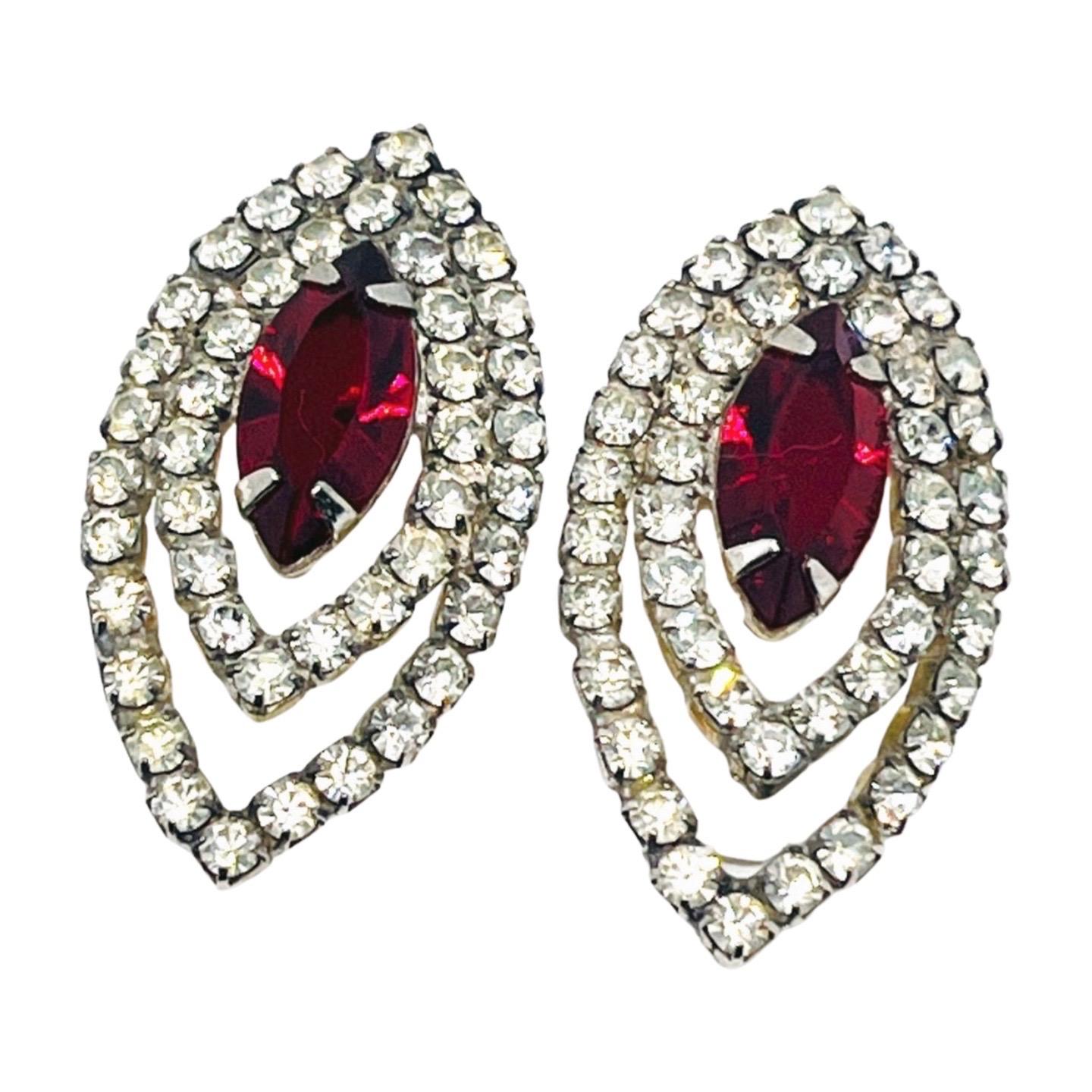 Dark Crystal Marquise Garnet, Pierced Earrings, Diamond-cut Cubic Zirconia Double Halo, Prongset with Welded Back. 

These are so dazzling and have that rainbow glint of light that one loves about cubic zirconias. The oblong marquise faux garnet has