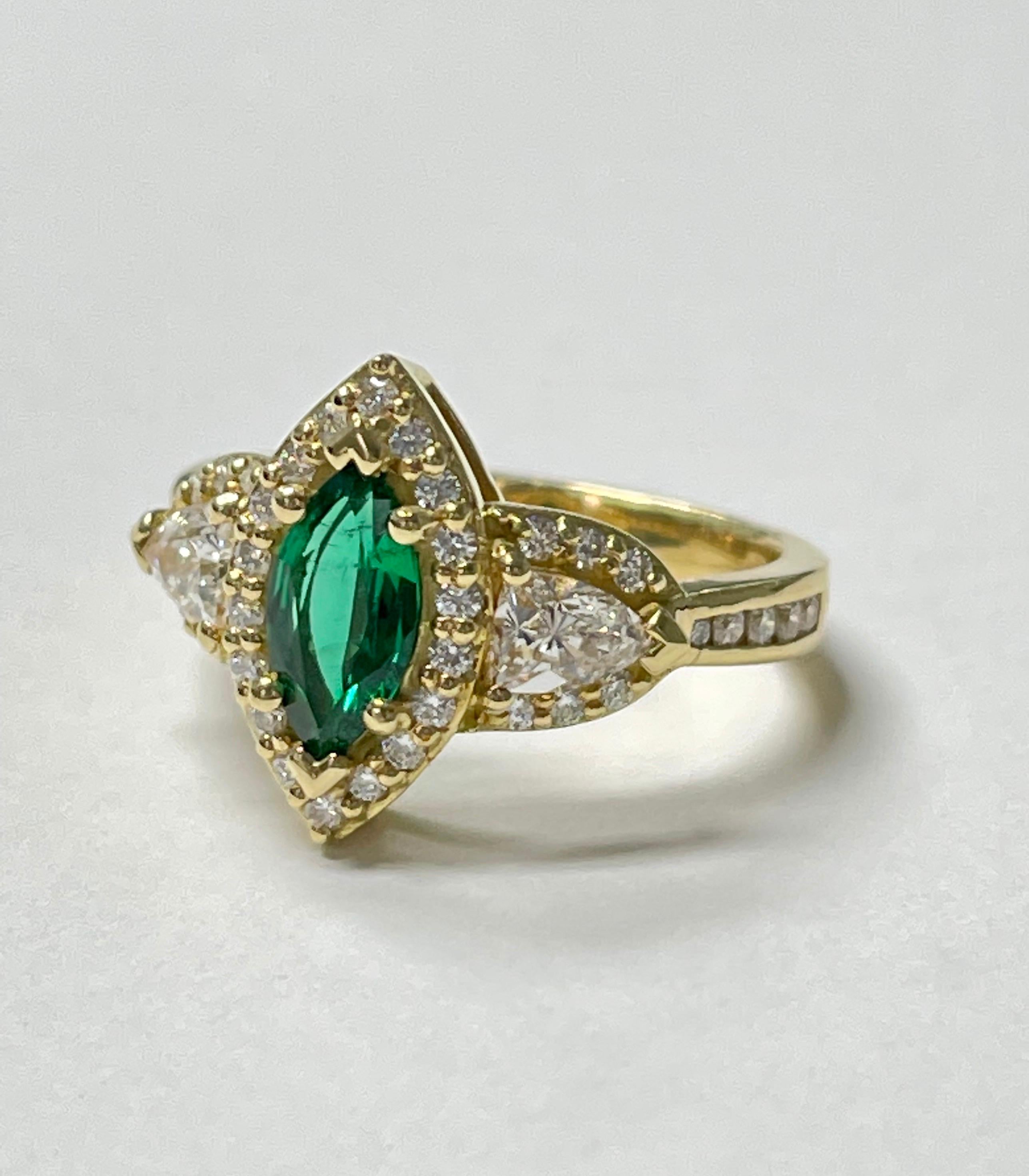 Marquise emerald and diamond engagement ring hand crafted in 18k yellow gold. 
The details are as follows : 
Emerald weight : 0.50 carat 
Diamond weight : 1.03 carat 
Metal : 18k yellow gold 
Measurements : ring head : 0.35 inch 
