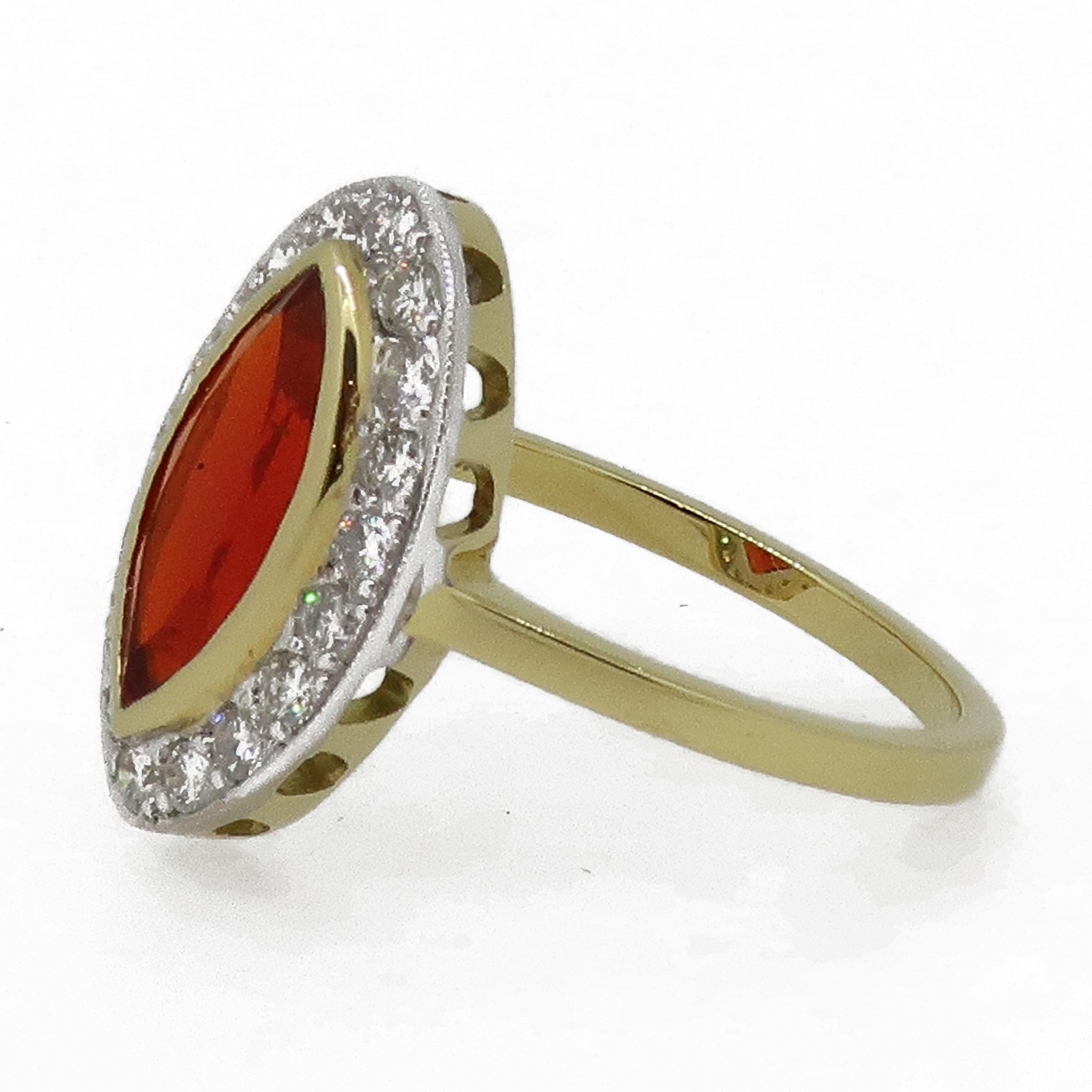 Marquise Fire Opal and Diamond Cluster Ring 18 Karat Yellow and White Gold

Stunning and classic marquise shaped fire opal weighing 1.06ct, encased in a fine yellow gold bezel surrounded by white brilliant cut diamonds. All diamonds are set in a