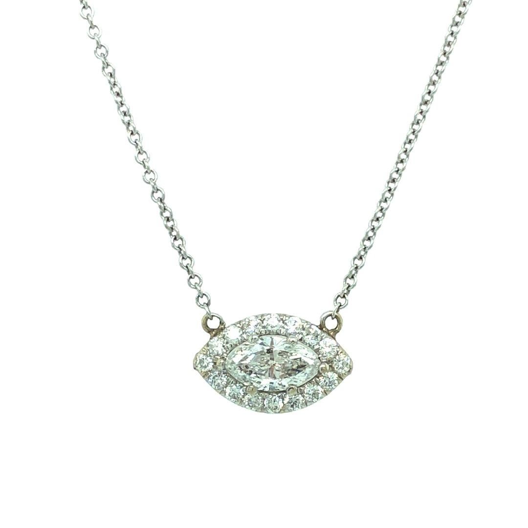 Simplicity with contemporary style, this lovely diamond necklace features a 0.75 carat with H color and SI clarity. Framed around the center stone are round brilliant cut diamonds weighing approximately 0.32 carat in total. The pendant measures 8mm