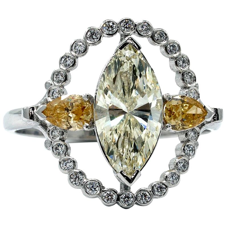 Marquise Halo Ring in 18 Karat White Gold with White and Yellow Diamonds For Sale