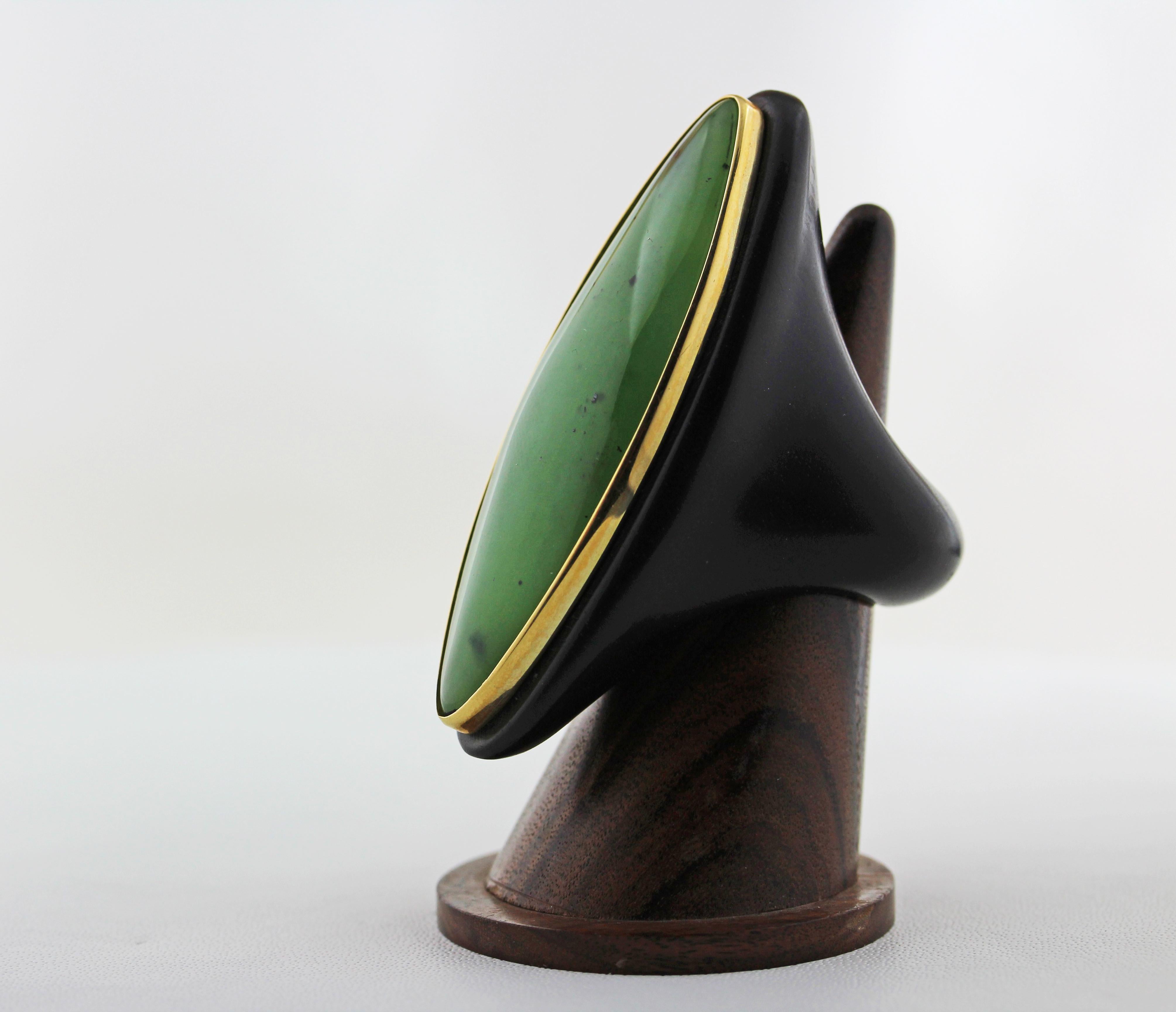 This incredible ring is totally hand-carved not only the stone but also the wood , the jade is shape as marquise and thanks to his vivid green color is an unique piece.
The center stone is surrounded by a band in 18 karat yellow gold and the