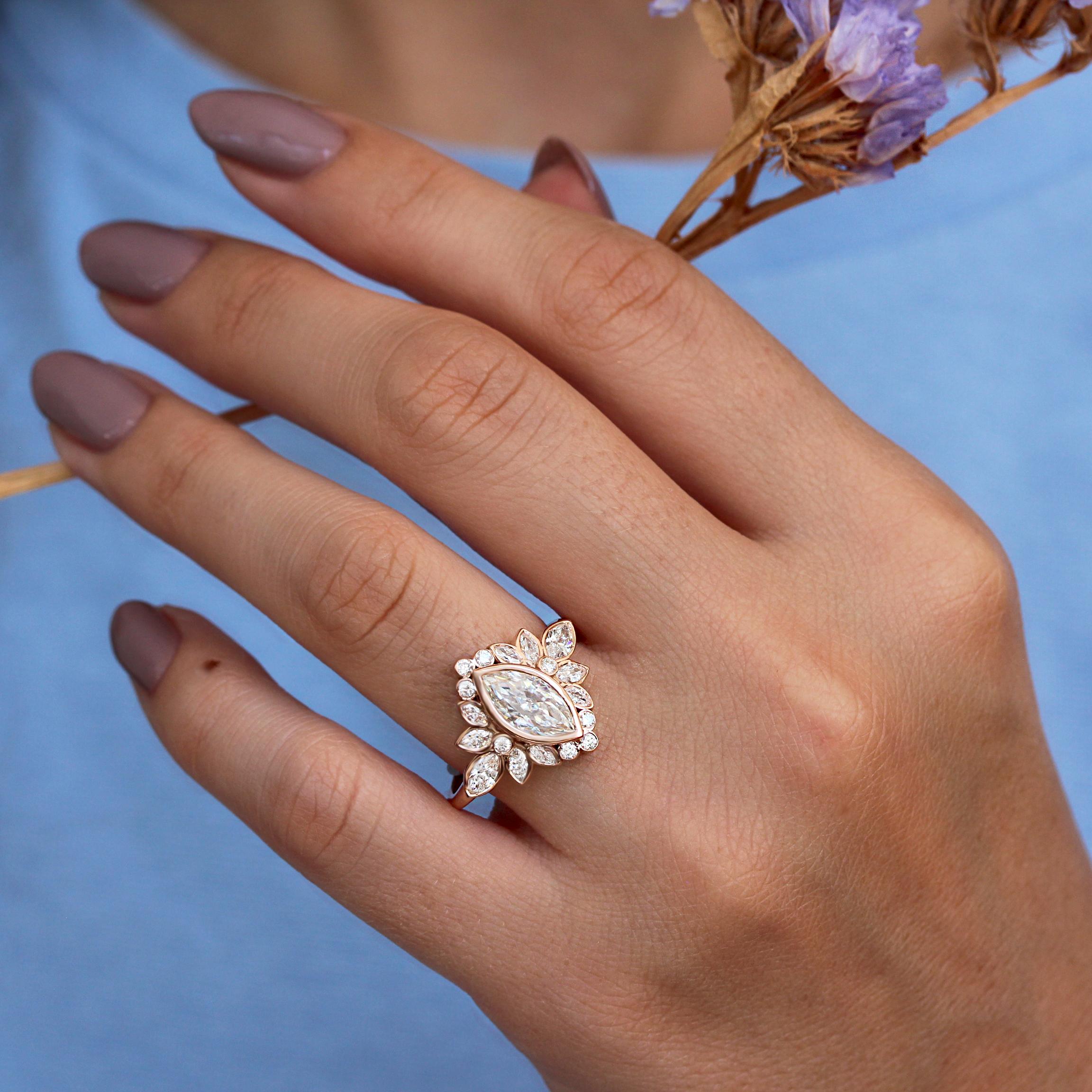 Beautiful Marquise Moissanite Floral cluster Engagement Ring, all diamonds are bezel set. Designed by Silly Shiny Diamonds.
 A Luxurious and unique design, handmade with ethical and environmentally friendly stones. 
The perfect ring that doesn't