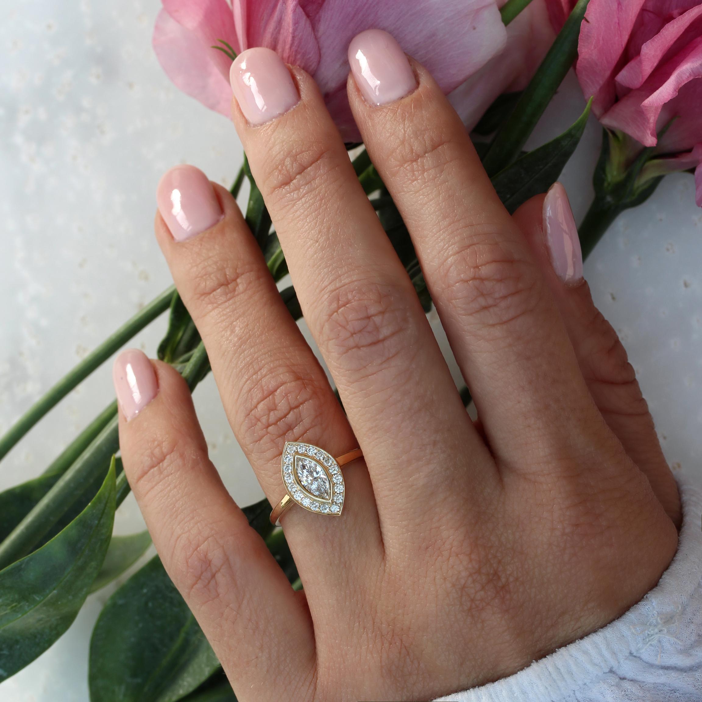 Marquise-shaped moissanite, bezel set, with a natural diamond halo - Classic and Elegant Ring. 
This list is for the engagement ring only.
This is made to order. Handmade with care. 
An original design by Silly Shiny Diamonds. 

Details: 
* Center