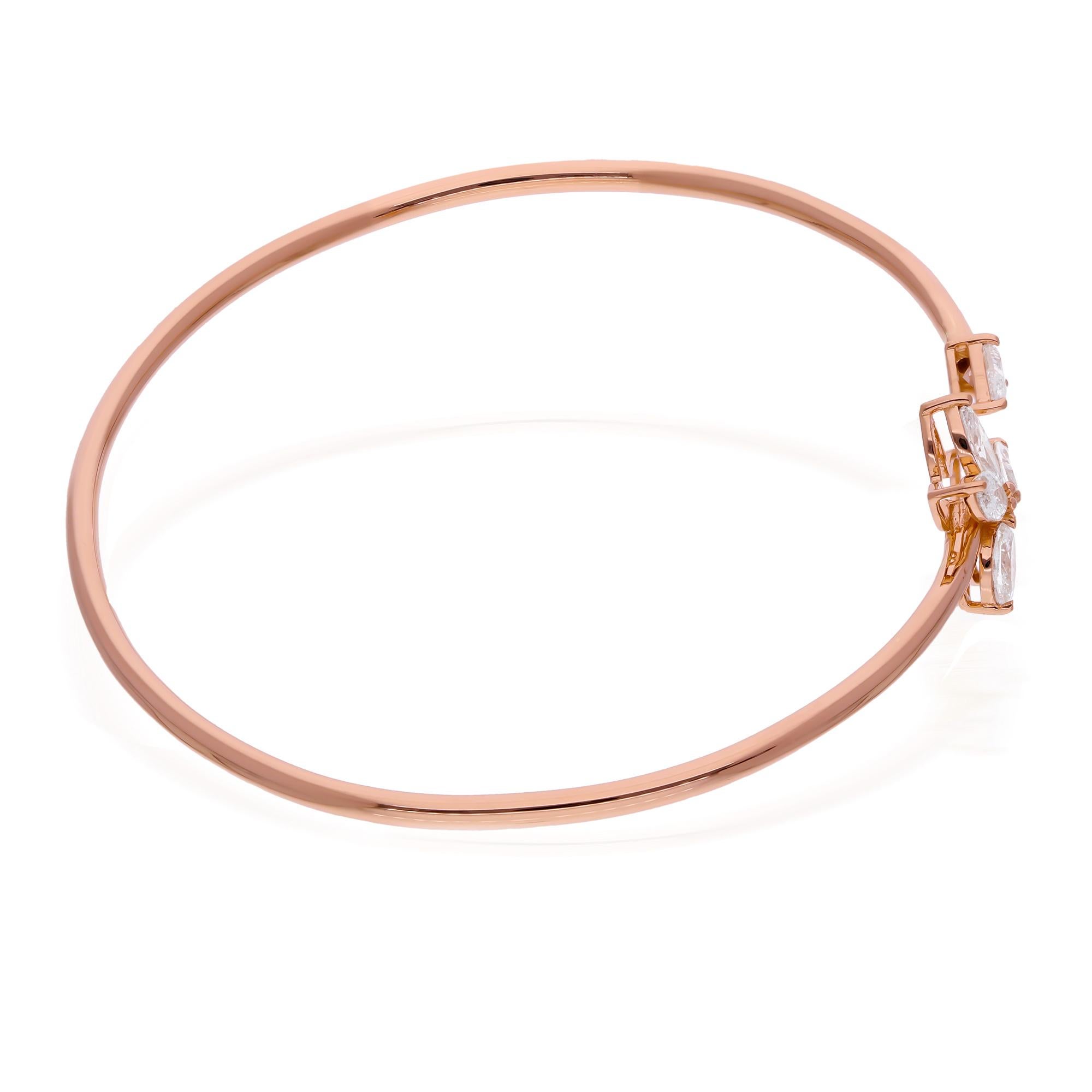 The warm embrace of 14 karat rose gold lends a soft, romantic hue to the piece, complementing the dazzling diamonds with its lustrous glow. The smooth curves of the cuff bracelet wrap around the wrist with effortless grace, offering both comfort and