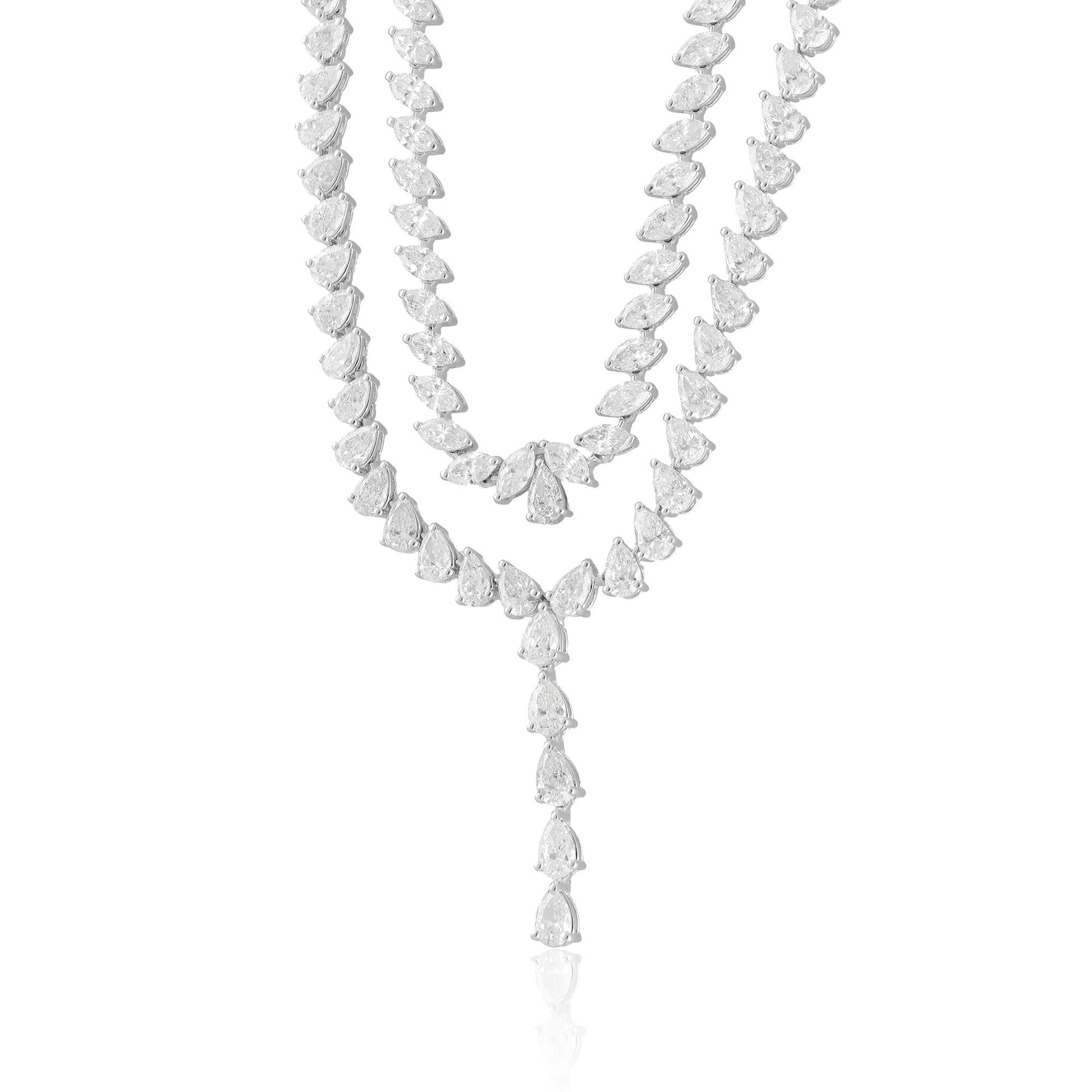 We're describing a lariat necklace made from 14 karat white gold, featuring a combination of marquise and pear-shaped diamonds. This necklace is characterized as handmade jewelry, indicating that it has been crafted with individual attention and