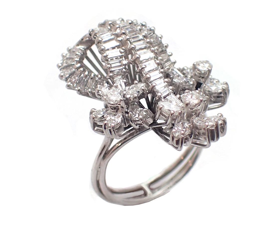 Give her a beautiful bouquet - made entirely of diamonds! This stunningly feminine and fun piece is the perfect addition to any formal event. It features over 3ct of round, marquise, and baguette diamonds, and is set in 14kt white gold. It fits
