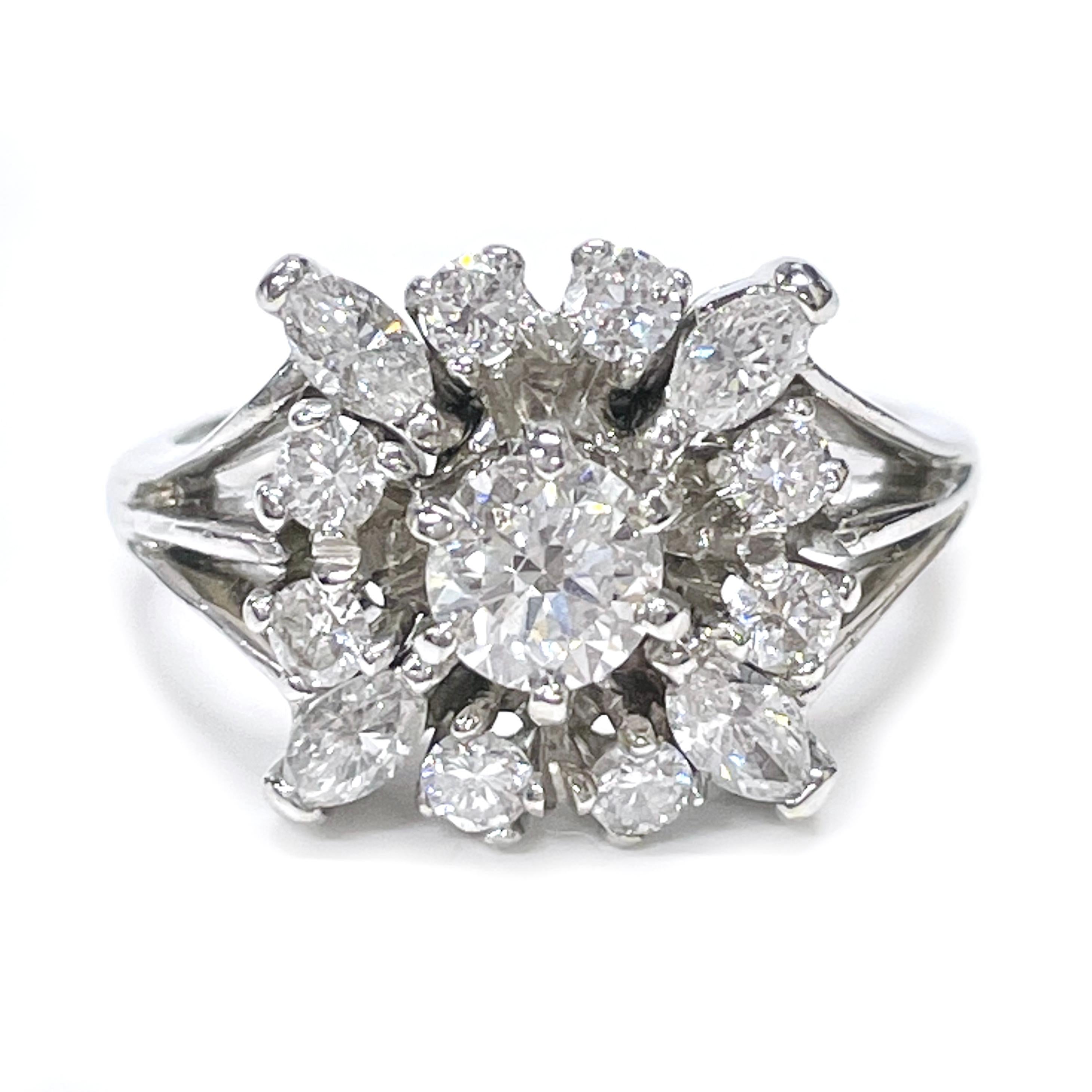 14 Karat White Gold Marquise and Round Diamond Ring. The center diamond is surrounded by two round diamonds on each side for a total of eight and a Marquise diamond at each corner for a total of four, all thirteen diamonds are prong set. Diamonds