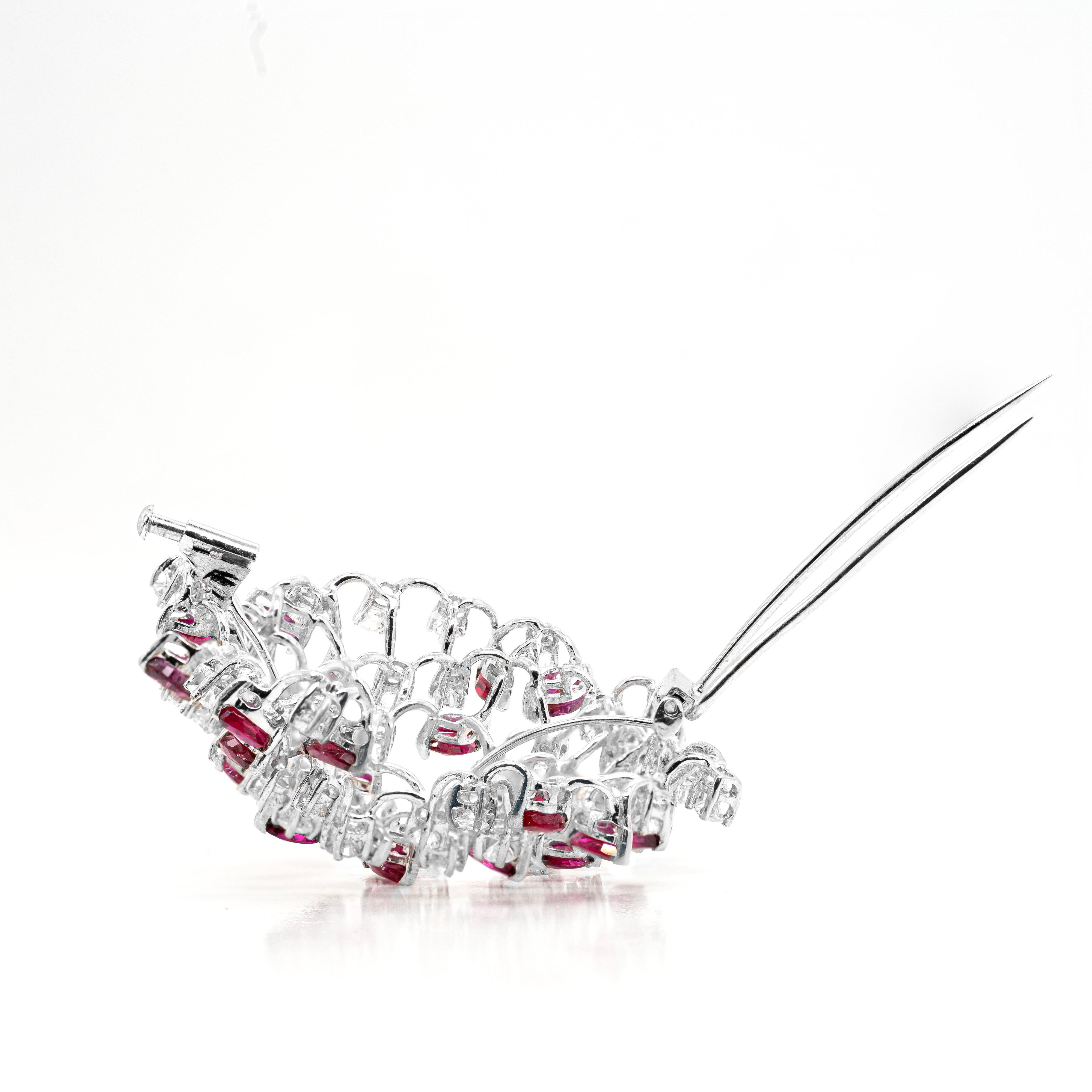 This wonderful one of a kind brooch is beautifully inlaid with a mix of 29 marquise shaped rubies and 36 high quality round brilliant cut diamonds spread throughout it among the vibrant rubies. All the stones are perfectly claw set on an 18 carat