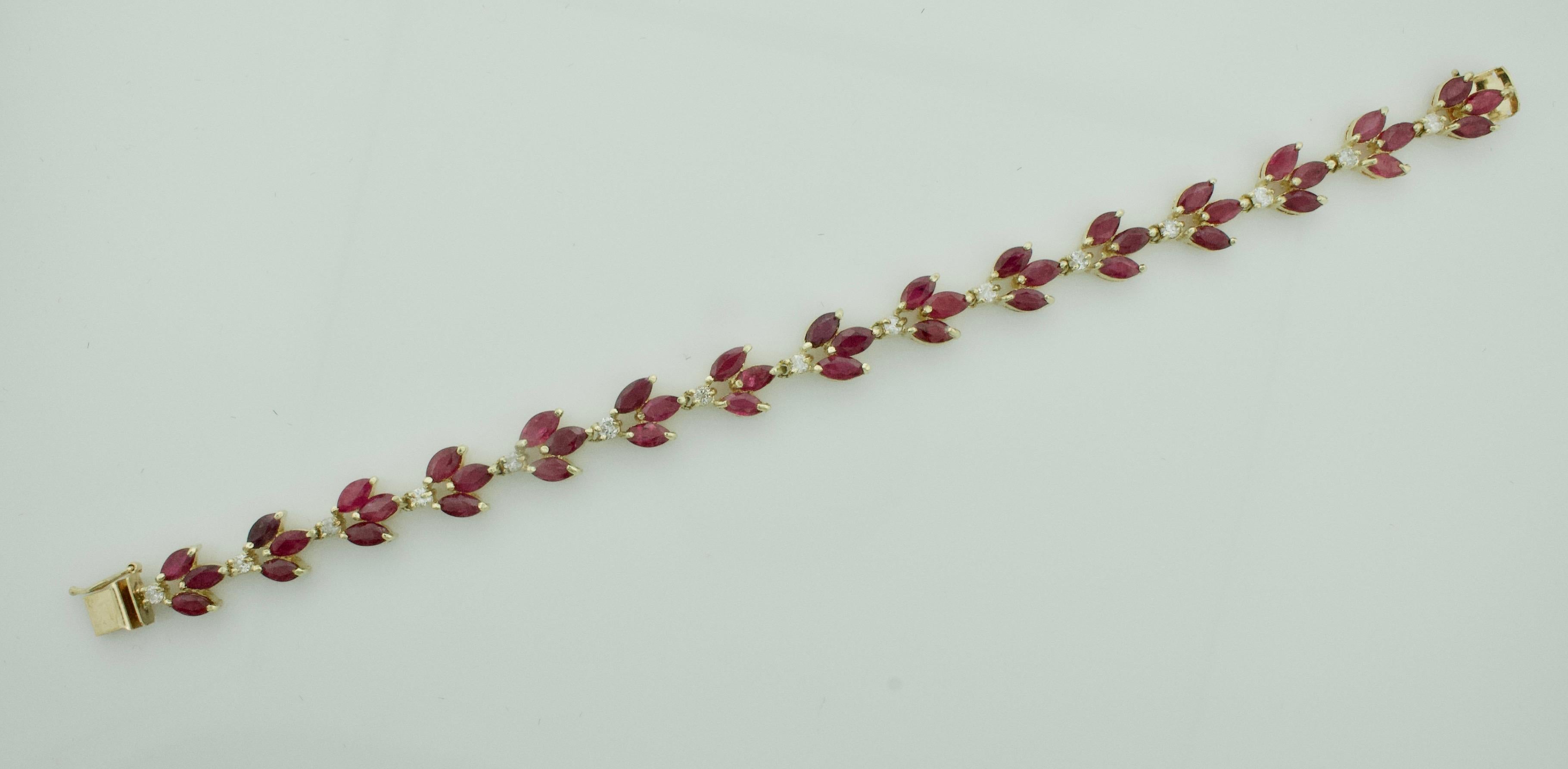 Marquise Ruby and Diamond Bracelet in Yellow Gold
Forty Five Marquise  Cut Rubies Weighing 15.00 Carats Approximately [bright with no imperfections visible to the naked eye]
Fifteen Round Brilliant Cut Diamonds Weighing .75 Carats Approximately GHI