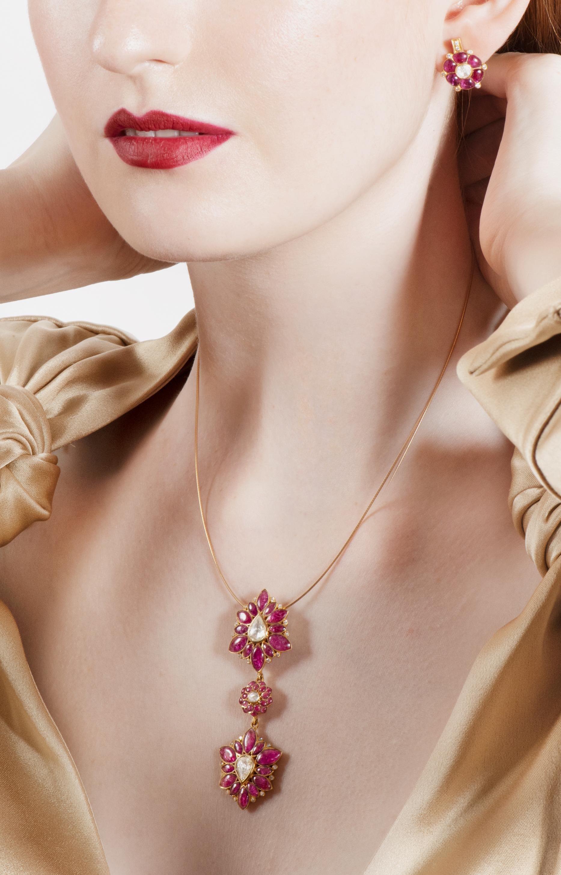Diamond weight: 0.26 carats
Rose-cut Diamond weight: 0.99 carats
Ruby weight: 8.51 carats

Two sparkling rose-cut teardrop diamonds are framed by marquise-cut rubies and  interspersed with full-cut diamonds.  Linked by a pretty floral motif the