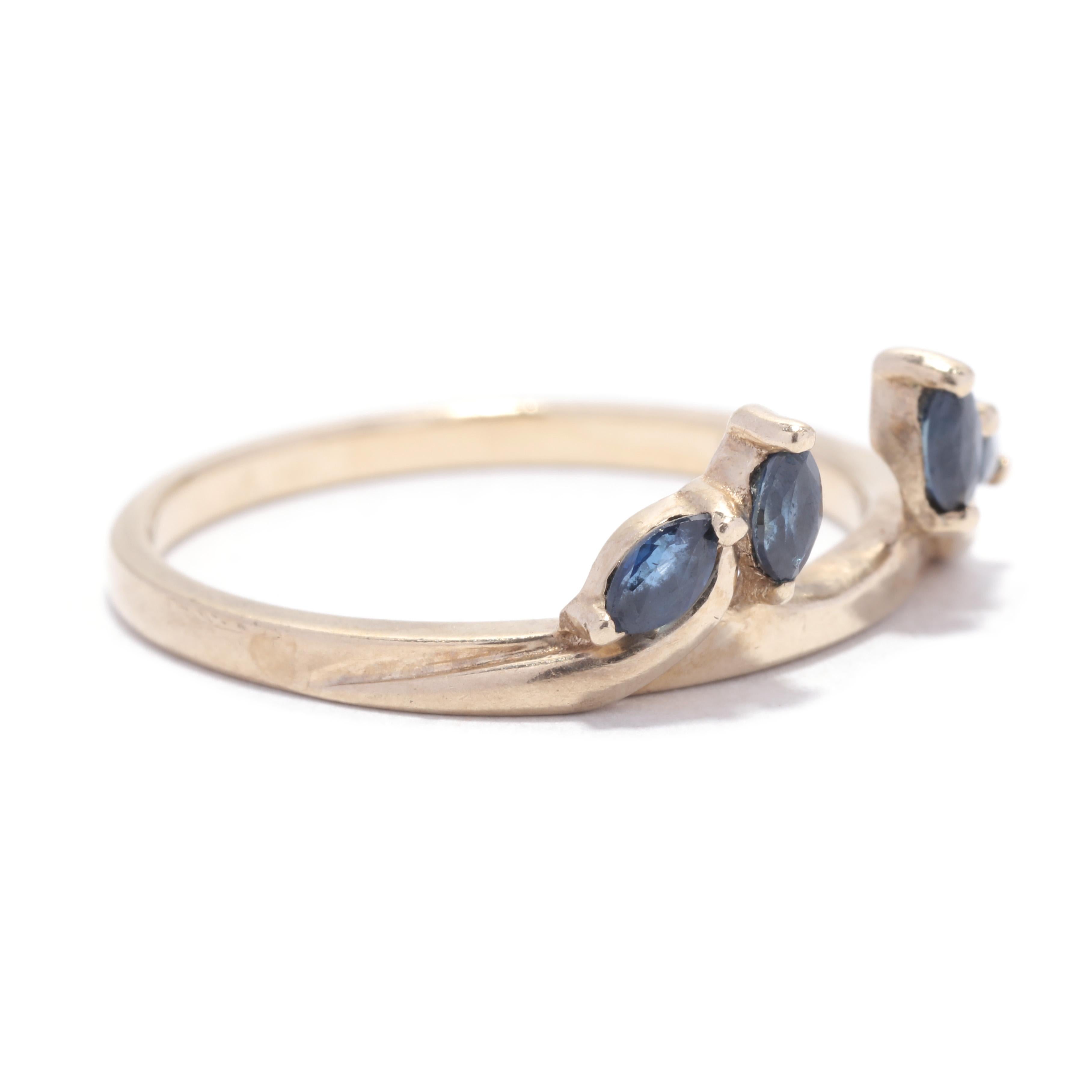 A vintage 10 karat yellow gold marquise sapphire wrap ring guard. This stackable ring jacket features two prong set marquise cut sapphires on either side weighing approximately .30 total carats and with a space in the center for a solitaire