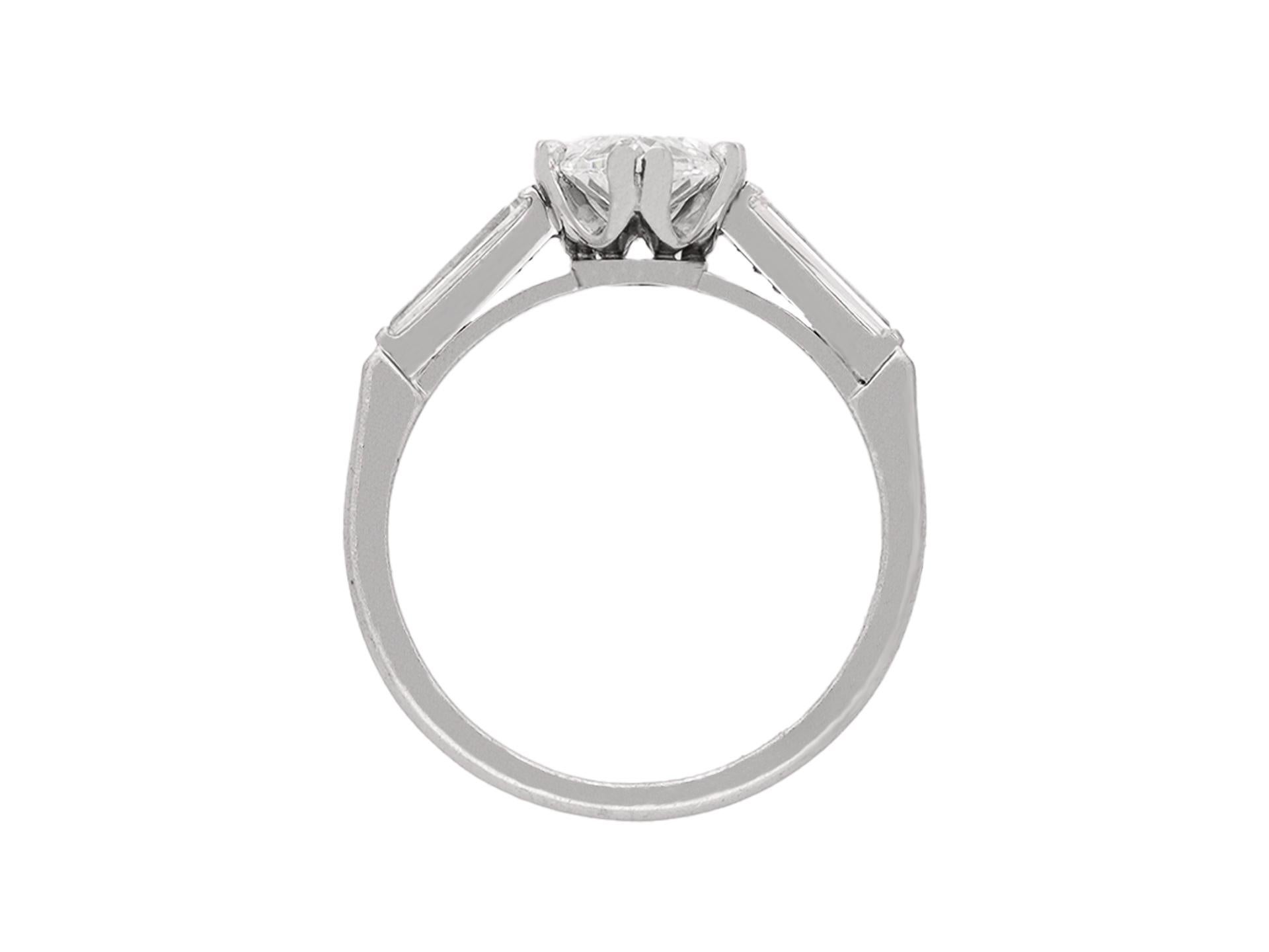 Marquise shape diamond flanked solitaire ring. Set to centre with a marquise shape old cut diamond, I colour, SI1 clarity, with a weight of 1.92 carats in an open back claw setting, flanked by two tapered baguette cut diamonds in open back rubover