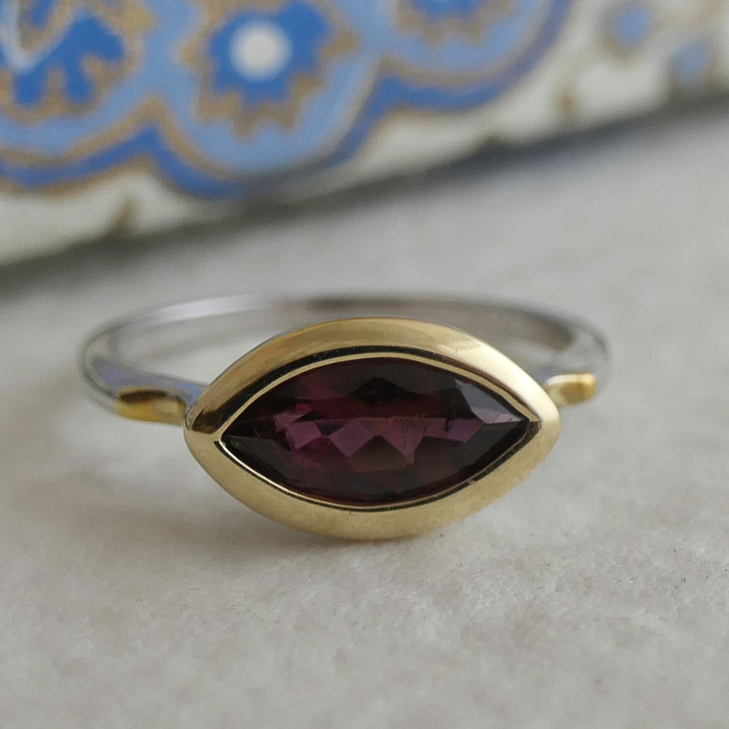 5x19mm marquise shape pink tourmaline is set in 14kt yellow gold.  The band is in sterling silver -- so everything that is yellow is 14kt yellow gold and everything you see that is silver is 925 sterling silver. 

Ring size is 7