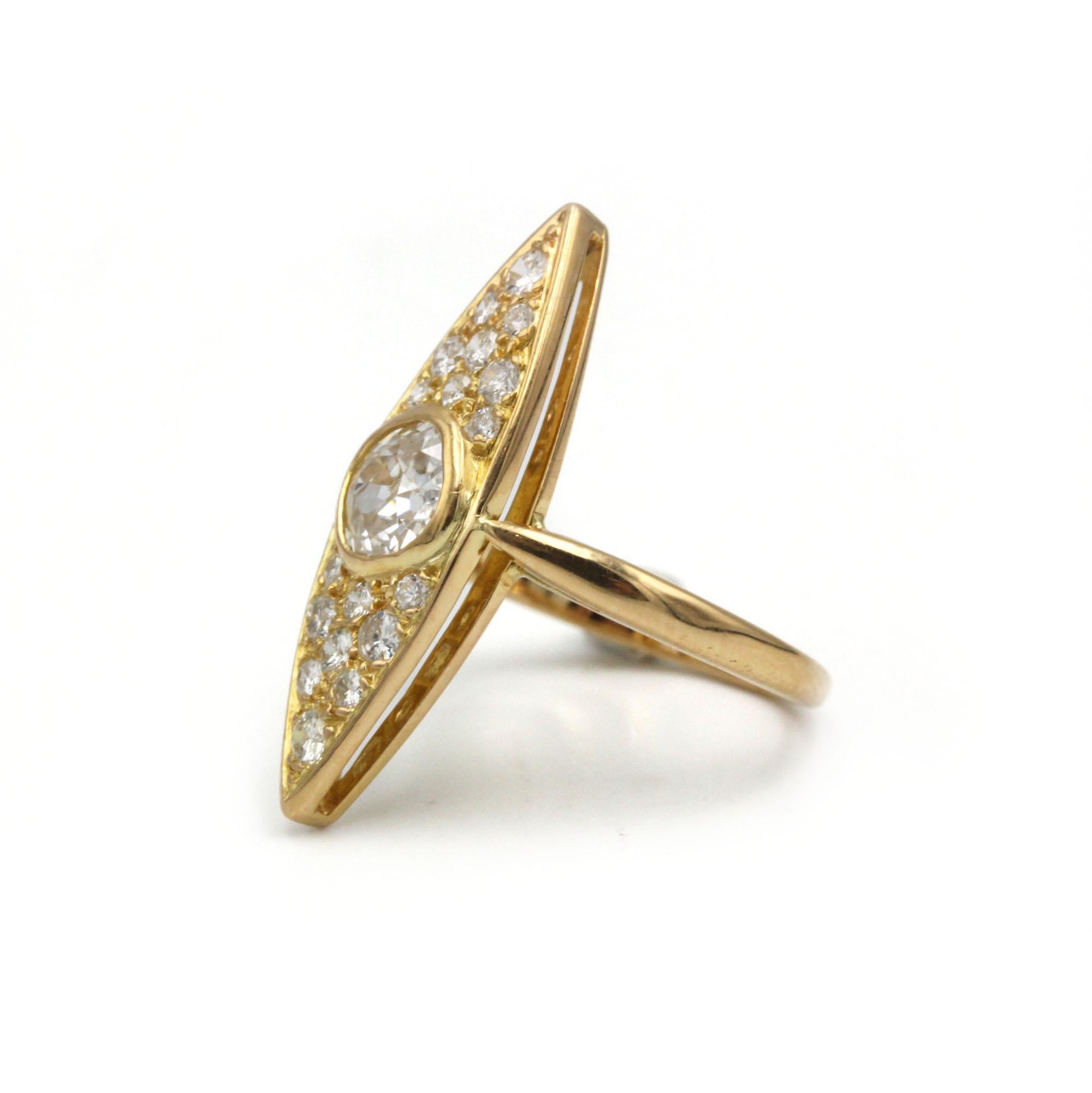 This striking navette-style ring, crafted in warm 18K yellow gold (750‰), features a bezel-set old-mine–cut diamond of approximately 0.70 carat at its center. The elongated marquise silhouette is paved with eighteen smaller old-mine–cut diamonds