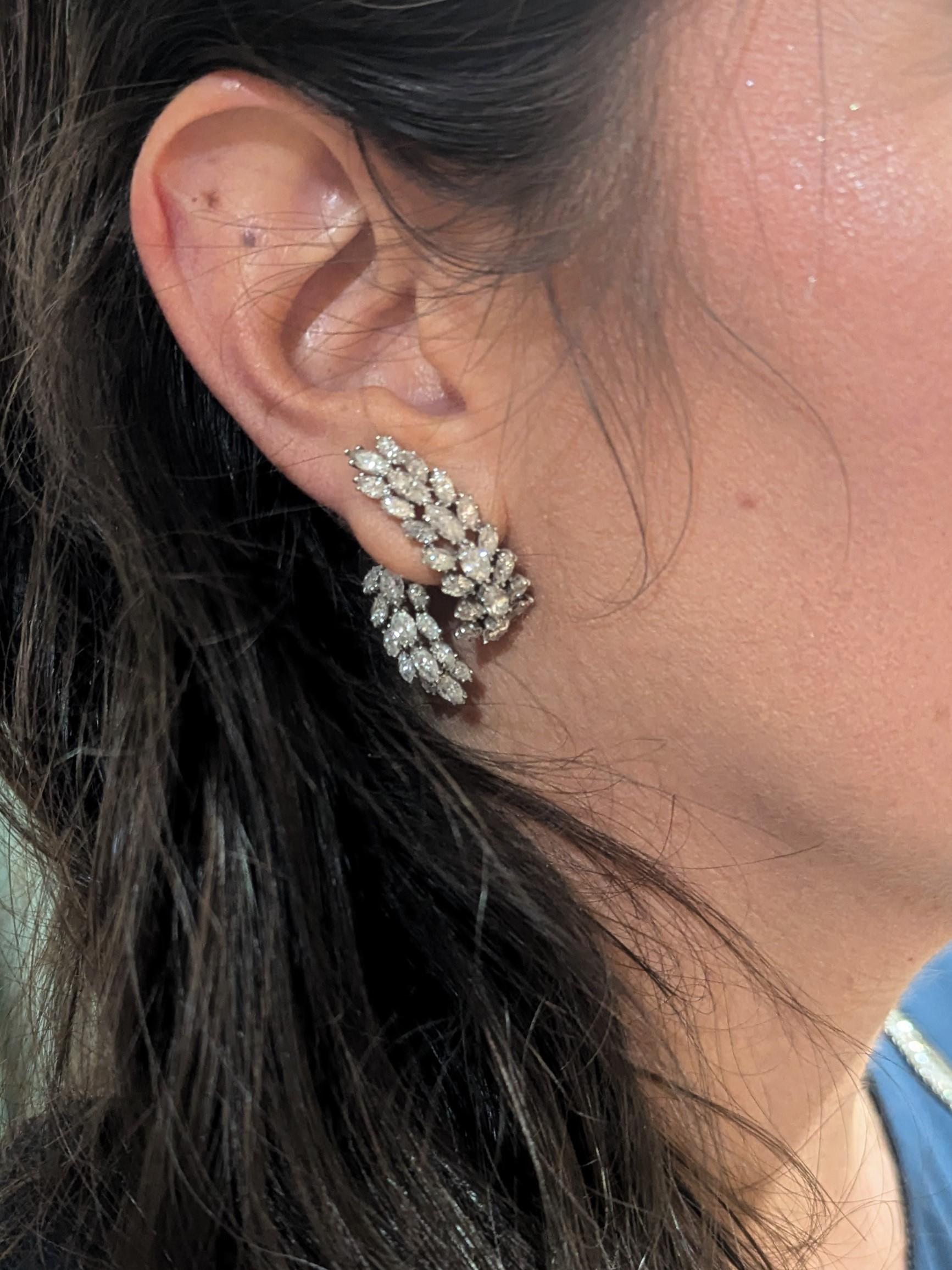 These earrings feature 70 marquise-shaped diamonds, weighing approximately 9.40 carats, organized in rows of 3 and meticulously set in platinum.