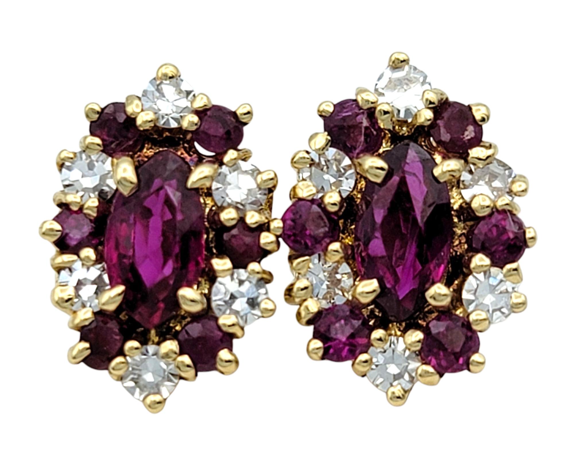 These lovely ruby and diamond stud earrings radiate classic charm with an elongated clustered composition. Each earring features a mix of marquise and round-cut rubies, carefully arranged to form a vibrant red centerpiece framed by glittering