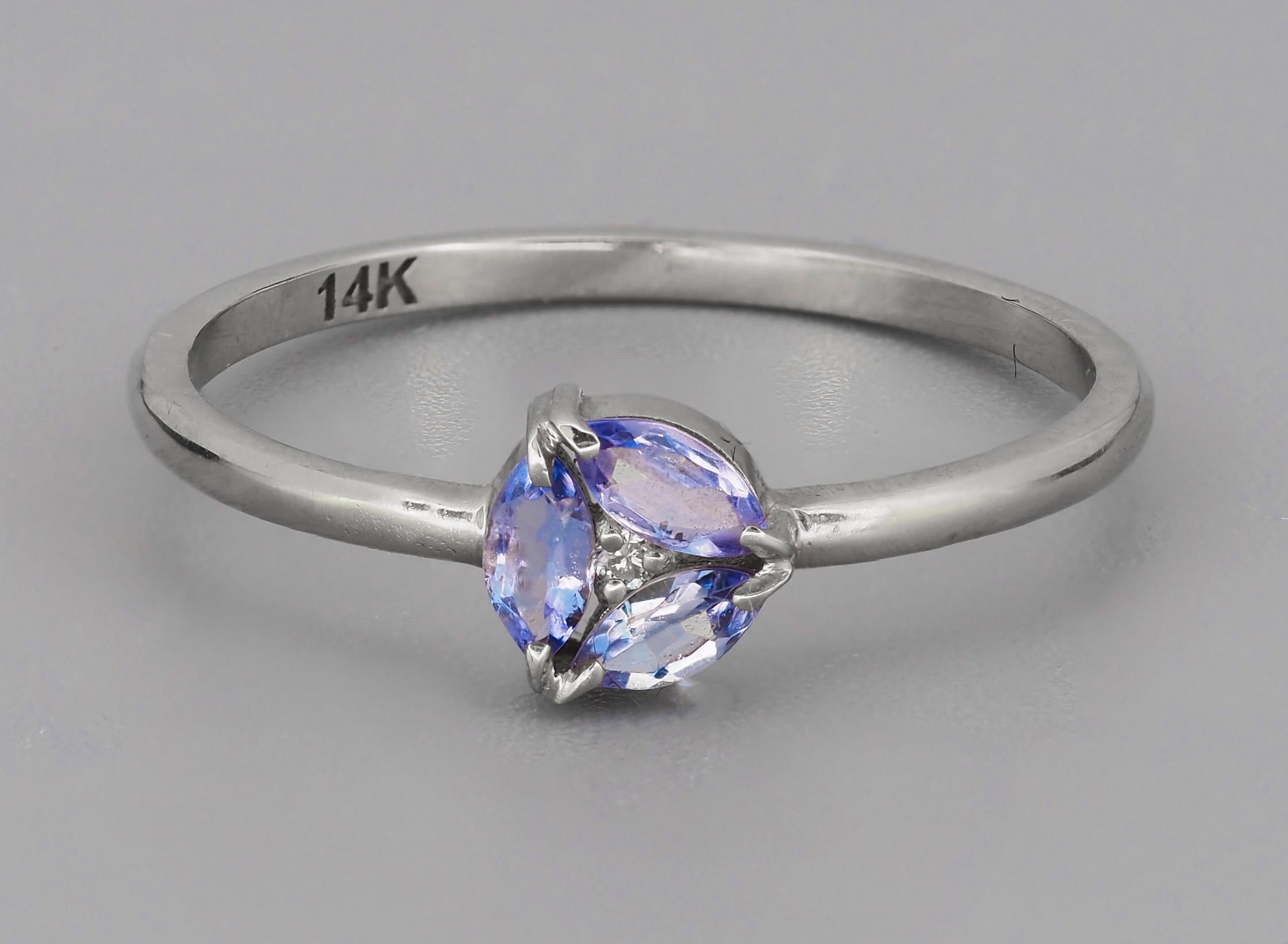 Marquise Tanzanite 14k gold ring. 
Minimalist tanzanite ring. December Birthstone ring. Delicate tanzanite ring. 3 gemstone ring.

Metal: 14k gold
Weight: 1.3 g. depends from size.

Set with tanzanites.
Marquise shape, light violetish blue color,