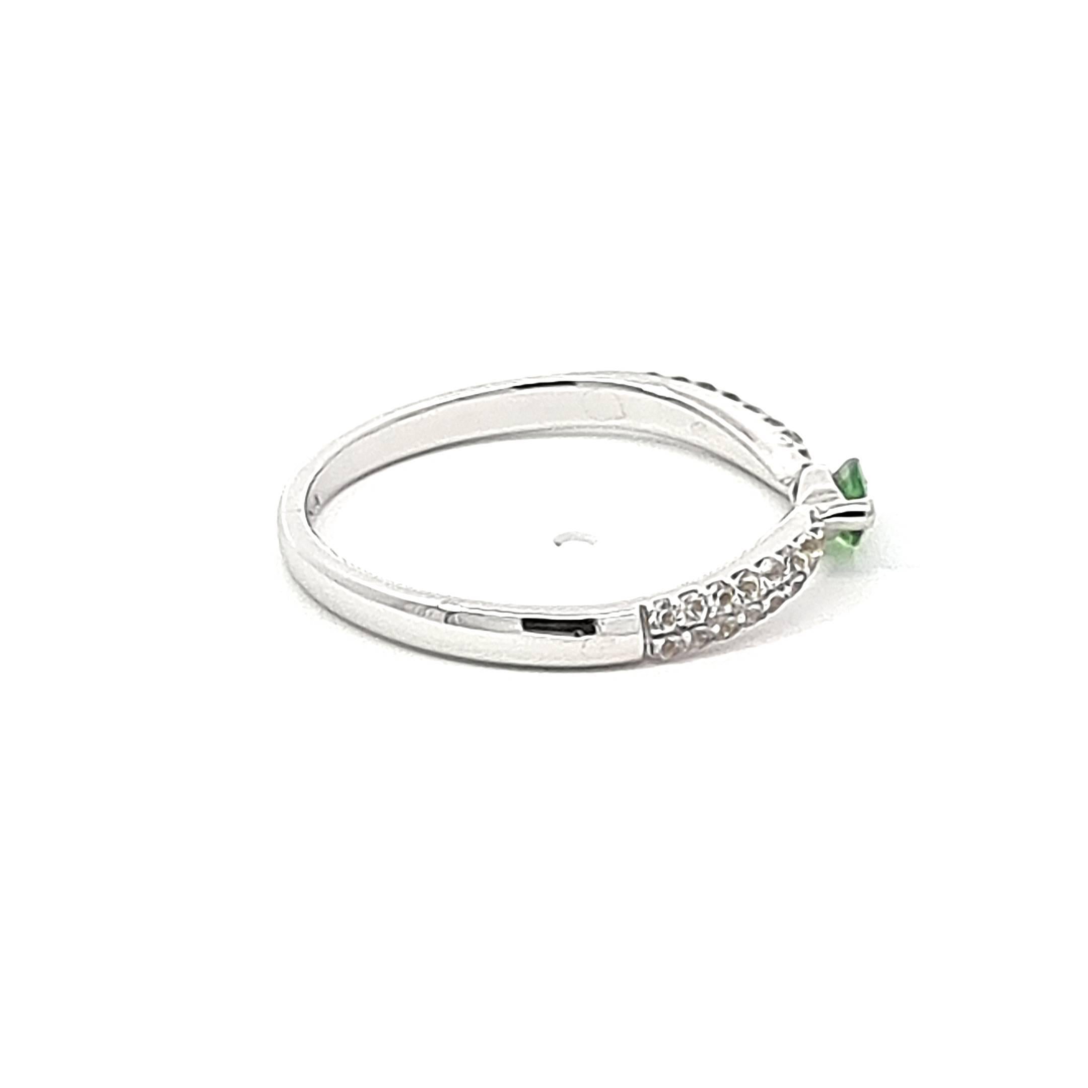 Elevate your elegance with our exquisite 14K White Gold Ring, a symphony of sophistication and charm. At its heart lies a mesmerizing marquise tsavorite, a vibrant green gemstone, commanding attention with its 0.22-carat brilliance. The curvaceous