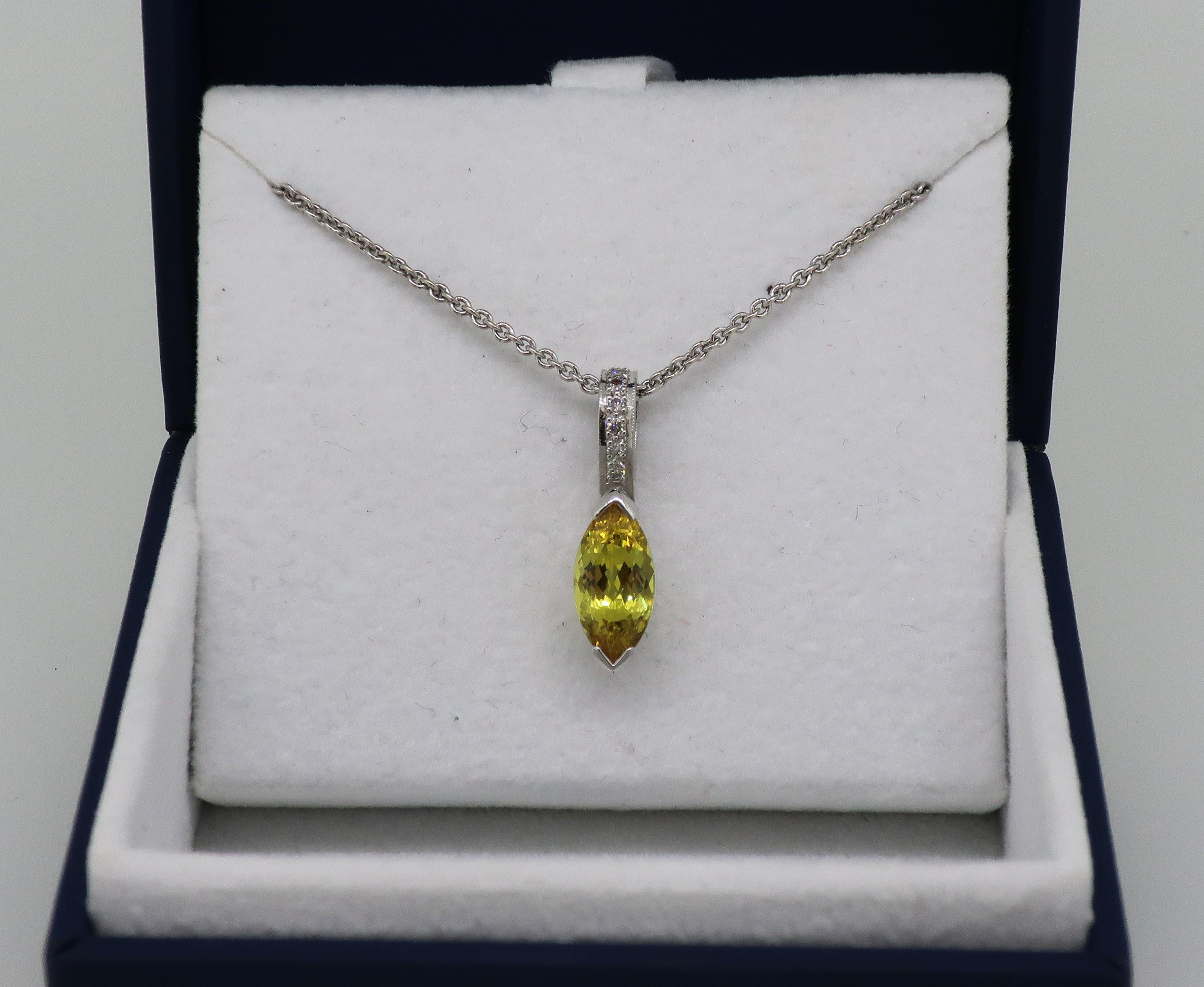 Yellow Sapphire and Diamond Pendant 18 Karat White Gold 

Gorgeous yellow sapphire and diamond pendant. Bright and vibrant marquise shape yellow sapphire measuring 10.5mm x 5.8mm, with a diamond set loop. The yellow sapphire is set in V shape claws