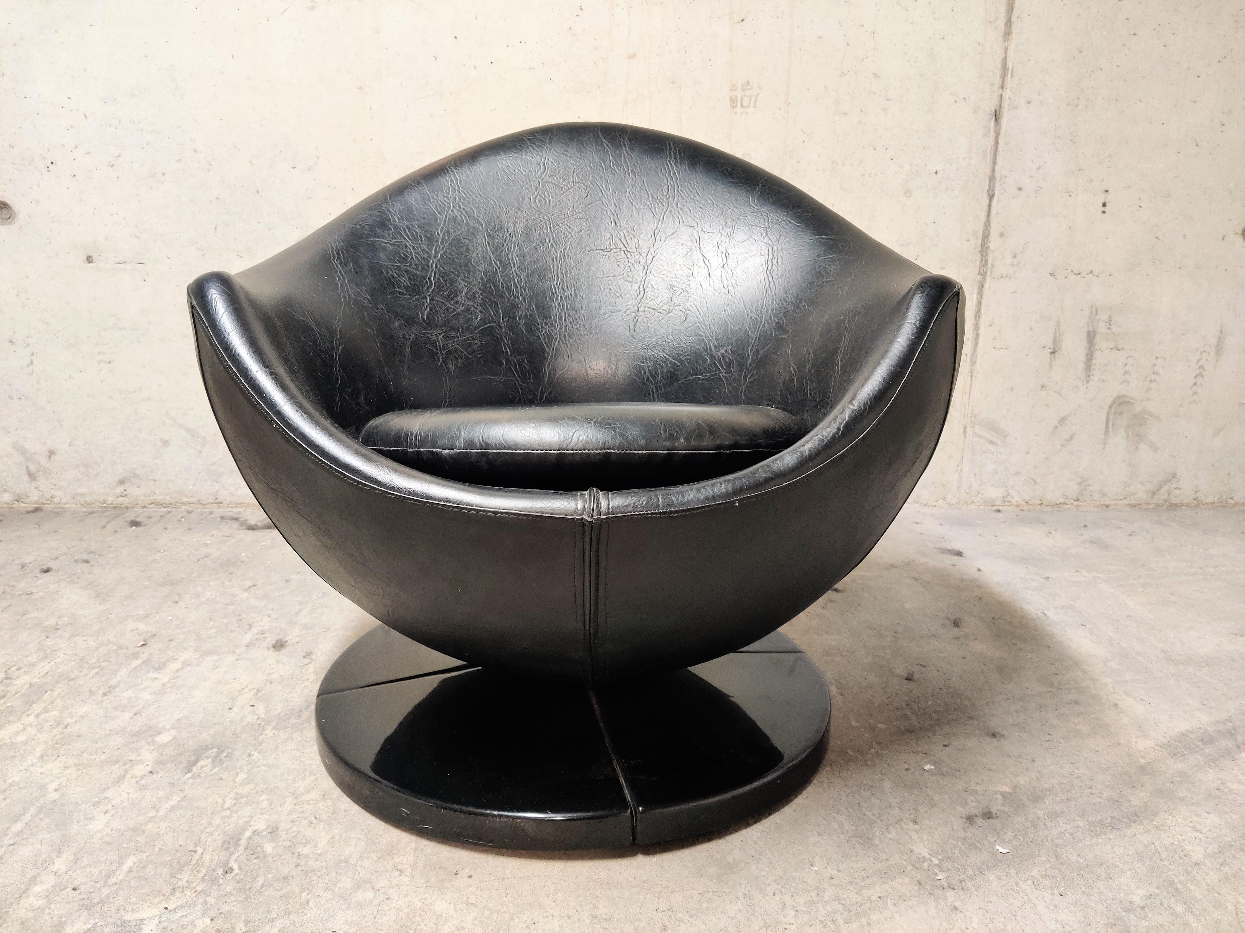 Midcentury swivel lounge chair model 'mars' designed by Pierre Guariche for Meurop.

The chair has a star shaped metal base with the intact original plastic cover and a with leatherette upholstered shell.

The chair is in good condition, with