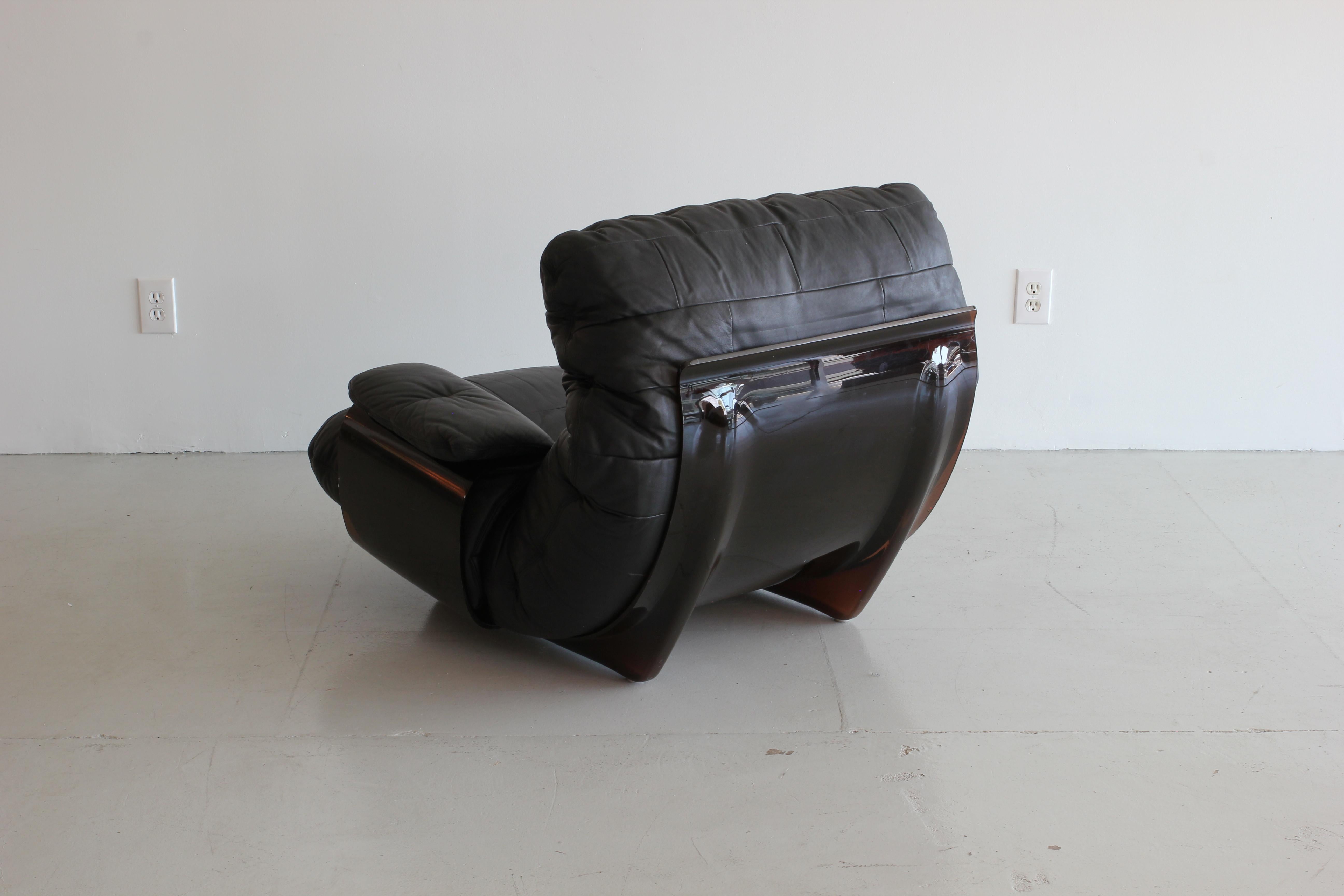 Incredible Marsala black leather lounge chair and matching ottoman by Michel Ducaroy manufactured by Ligne Roset in France during the 1970s. Original leather and logo on upholstery and frame. 

Ottoman measures 33