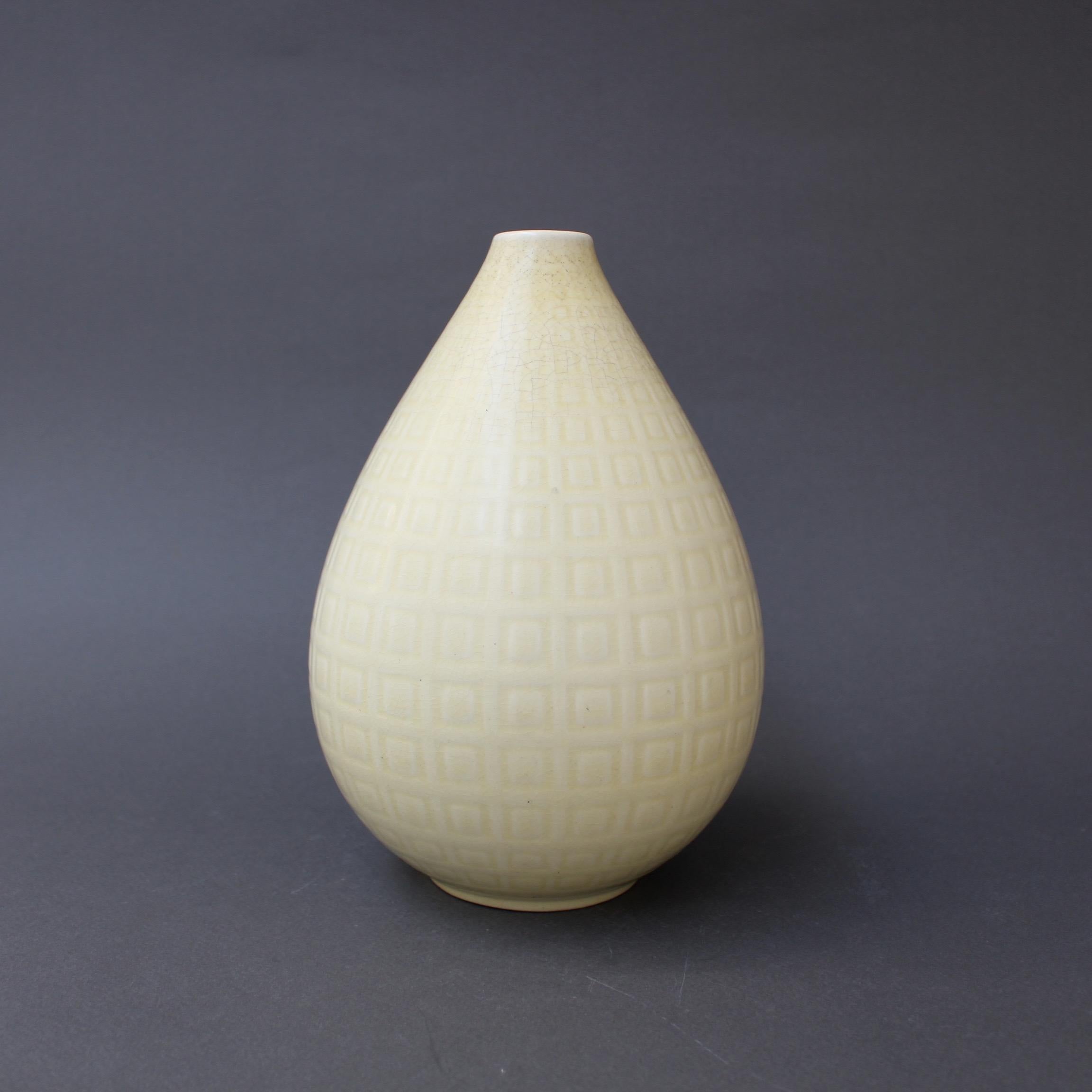 'Marselis' vase designed by Nils Thorsson for Aluminia - Royal Copenhagen, circa 1960s. A subtle square repeating pattern appears as the motif on a delicate beige and yellow teardrop-shaped flower vase. It is elegant with a light touch and very
