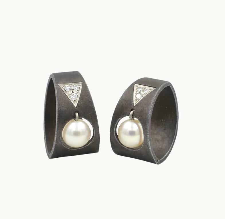 Marsh & Co. vintage earrings from circa 1930s.  Marsh's unique jewelry used blackened stainless steel in their designs. These earrings feature dangling pearls that swing with motion. Above them sit 3 full cut round diamonds set in a white gold