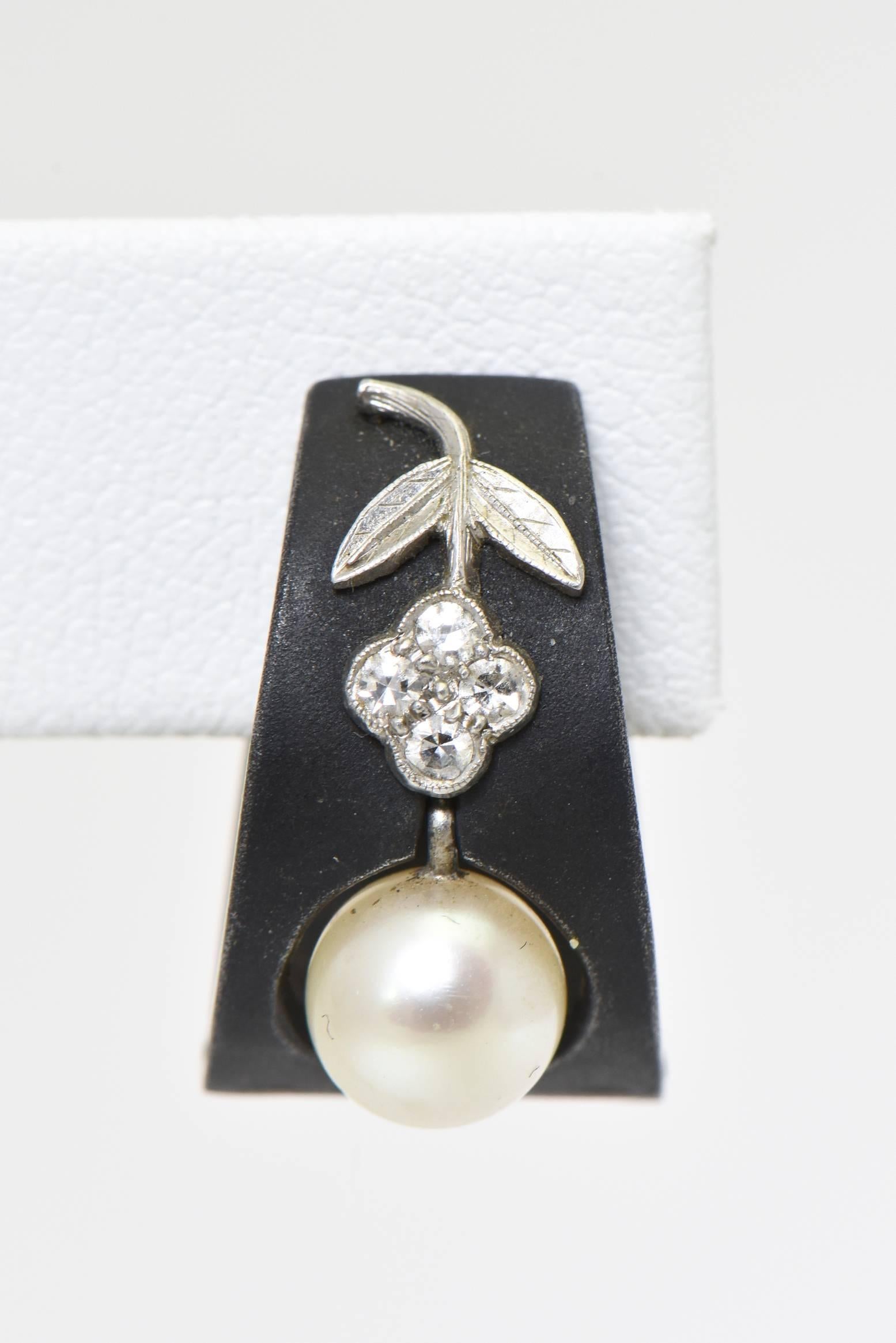 These hard to find earrings are part of my mother's personal collection.  Over the last 30 years, she has only found a few Marsh pieces.  These earrings feature cultured pearls dangling in a patinated steel geometric frame accented with a flower