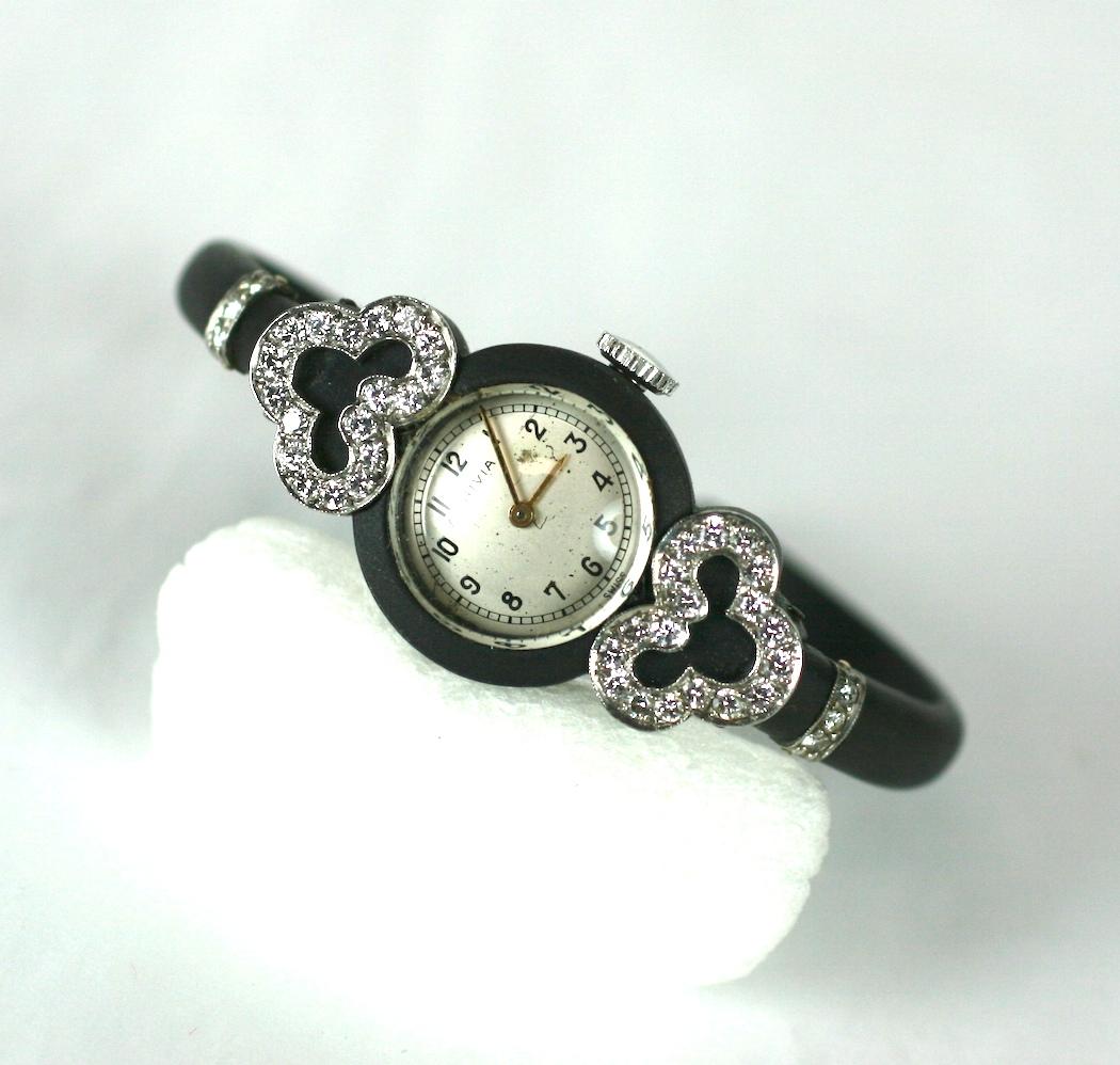 Attractive and elegant Marsh Art Deco steel, gold and diamond clamper style wrist watch. Patinaed steel with applied pave diamond cloud form motifs and shoulder hilts. 14k white gold back engraved in the signature March fashion. 
Small size,