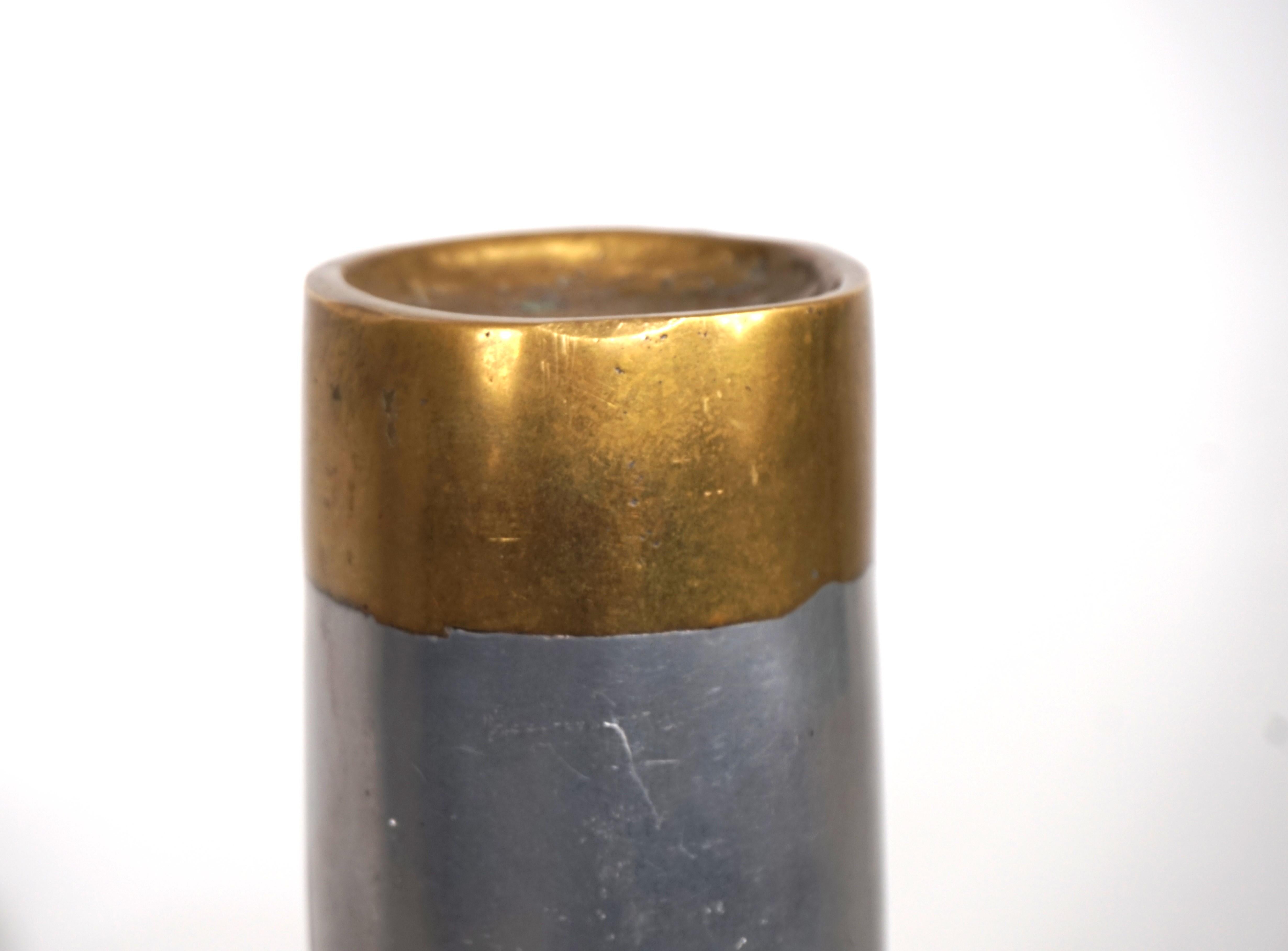 This brutalist sculpture, made of solid brass and aluminum, presents itself differently from every angle. The sculpture's curvature and the recessed center are the defining design features. The material mix of aluminum and brass is David Marshall's