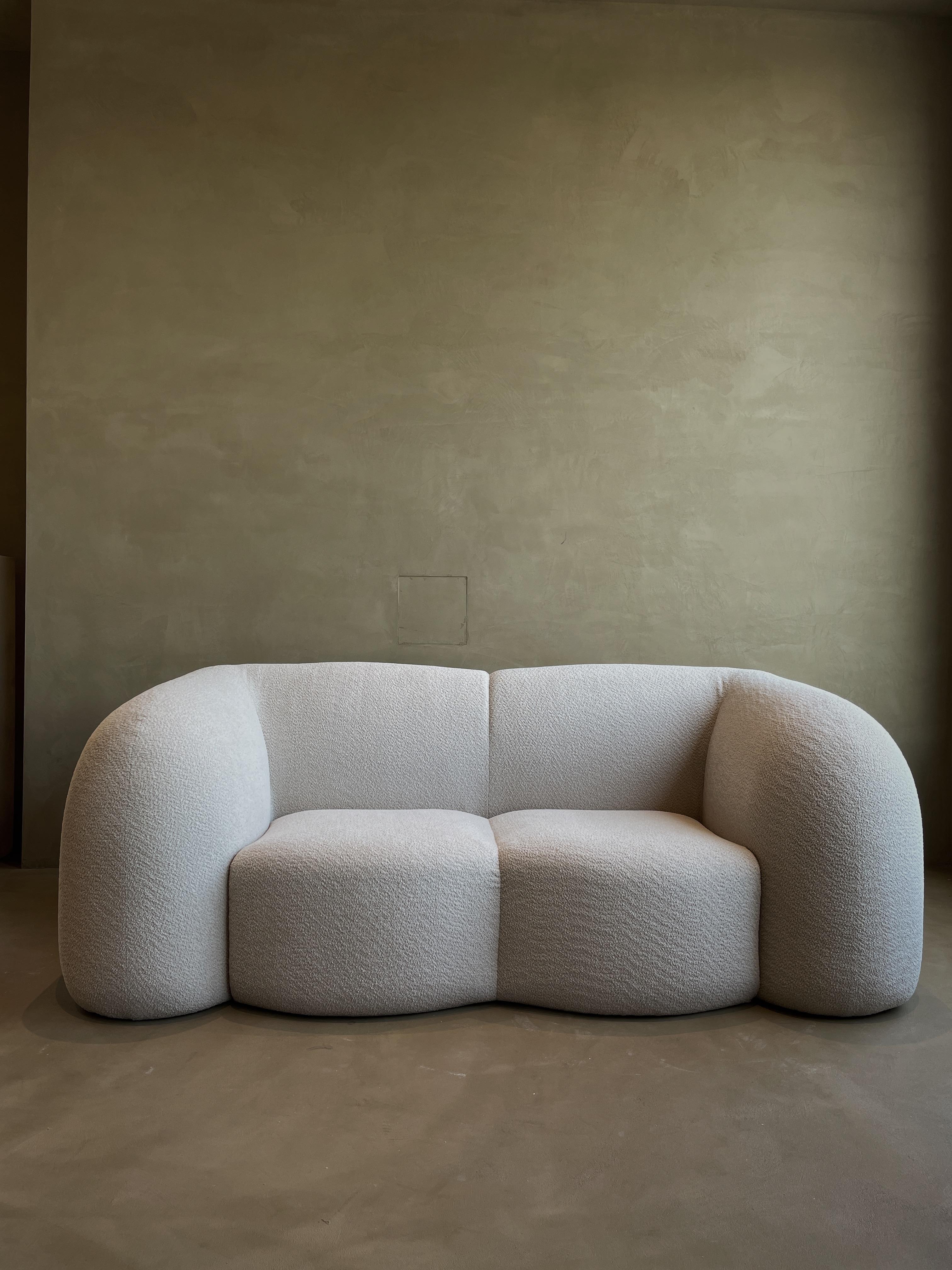 Marshmallow sofa by kar
Dimensions: W 213.5 x D 103 x H 80 cm
Materials: MDF frame, fabric
Colour can be customized. 

Kar, is the root of Sanskrit Karma, meaning karmic repetition. We seek the cause and effect in aesthetics, inspired from the past,