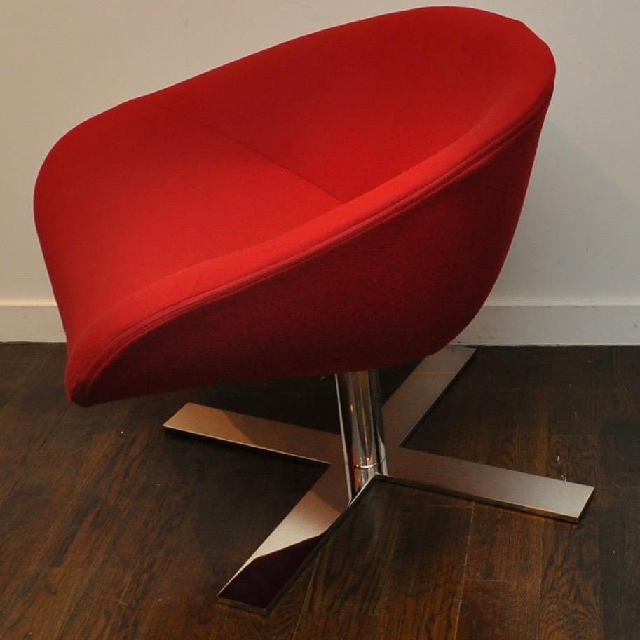 Gently used chair in red fabric atop a heavy, thick chrome swivel base in near perfect condition.