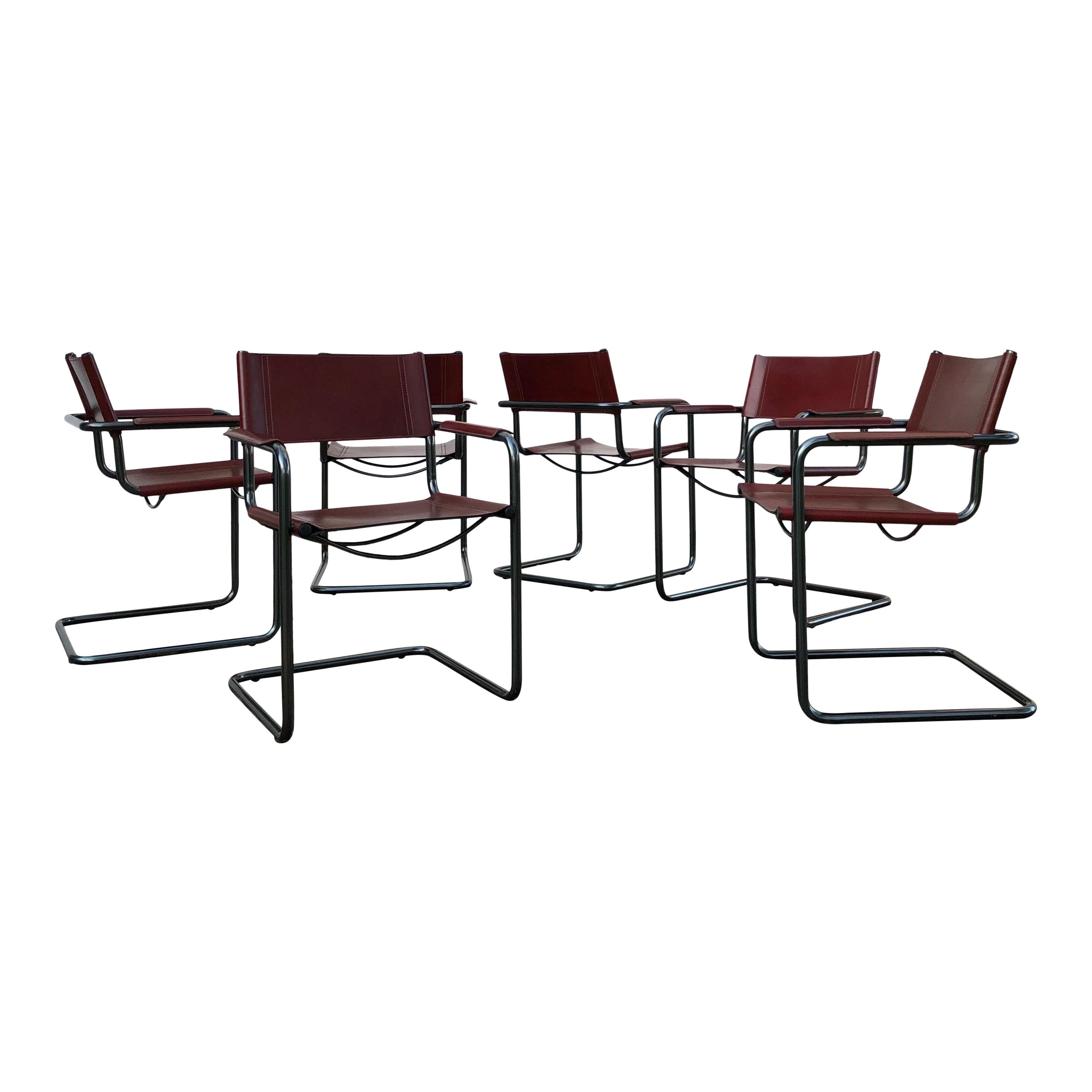 Set of Six MG5 Dining Chairs Designed by Mart Stam for Matteo Grassi, 1970s.

This set of six MG5 dining chairs features:
- Tubular dark grey anodized steel frames in a cantilever design
- Red leather seating, backrest, and armrests
- Signature