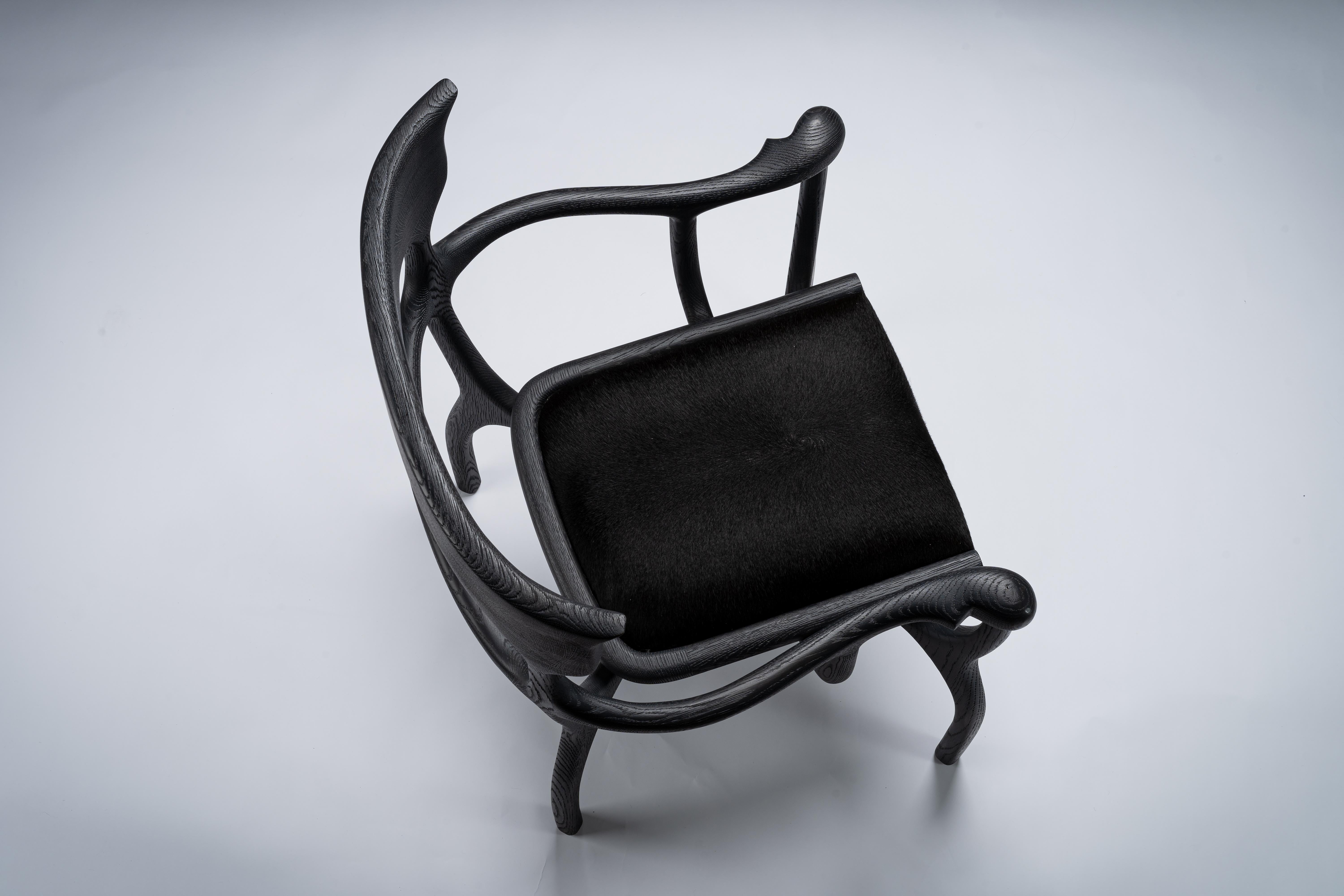 Hand-Carved MARTA Black Chair/Armchair in Walnut/Oak with Cowhide Seat by Mandy Graham For Sale