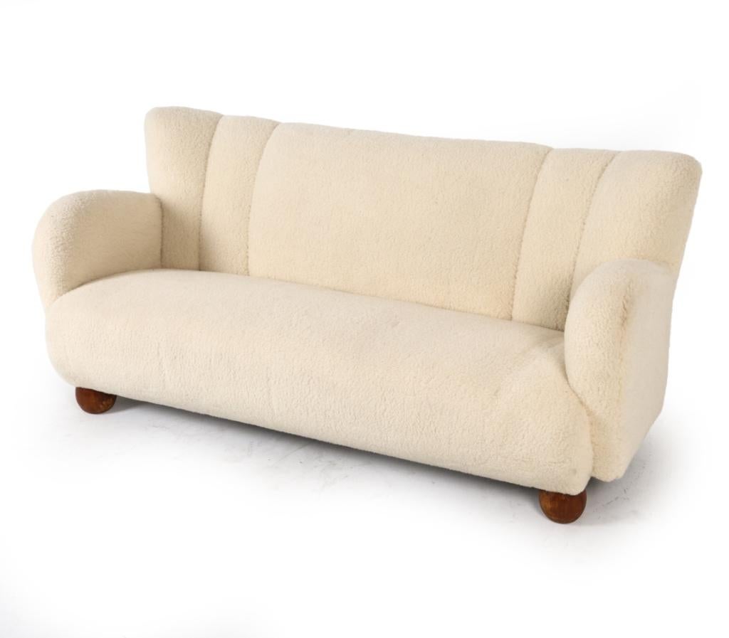 This exceptionally rare and elegant sofa was designed by the celebrated Finnish architect and designer, Marta Blomstedt. This piece is a sublime example of early Finnish modernism, showcasing Blomstedt's distinctive ability to blend comfort, organic