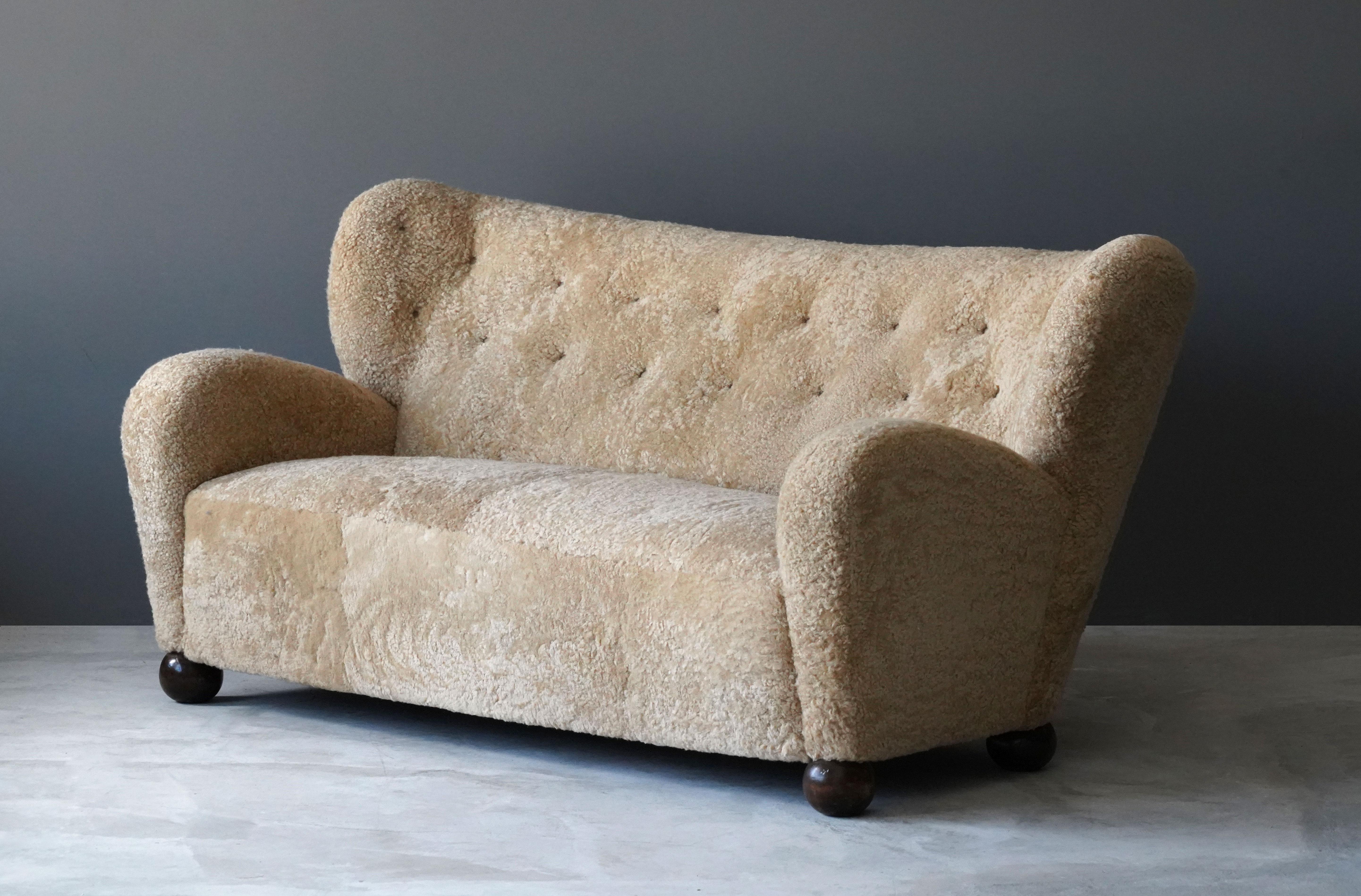 A large, organic sofa designed by Märta Blomstedt in 1939 for the lobby of Hotel Aulanko, Hämeenlinna, Finland. Overstuffed and upholstered in authentic natural beige sheepskin. Legs are stained birch.


Keywords: lambskin, lamb sheep hide,