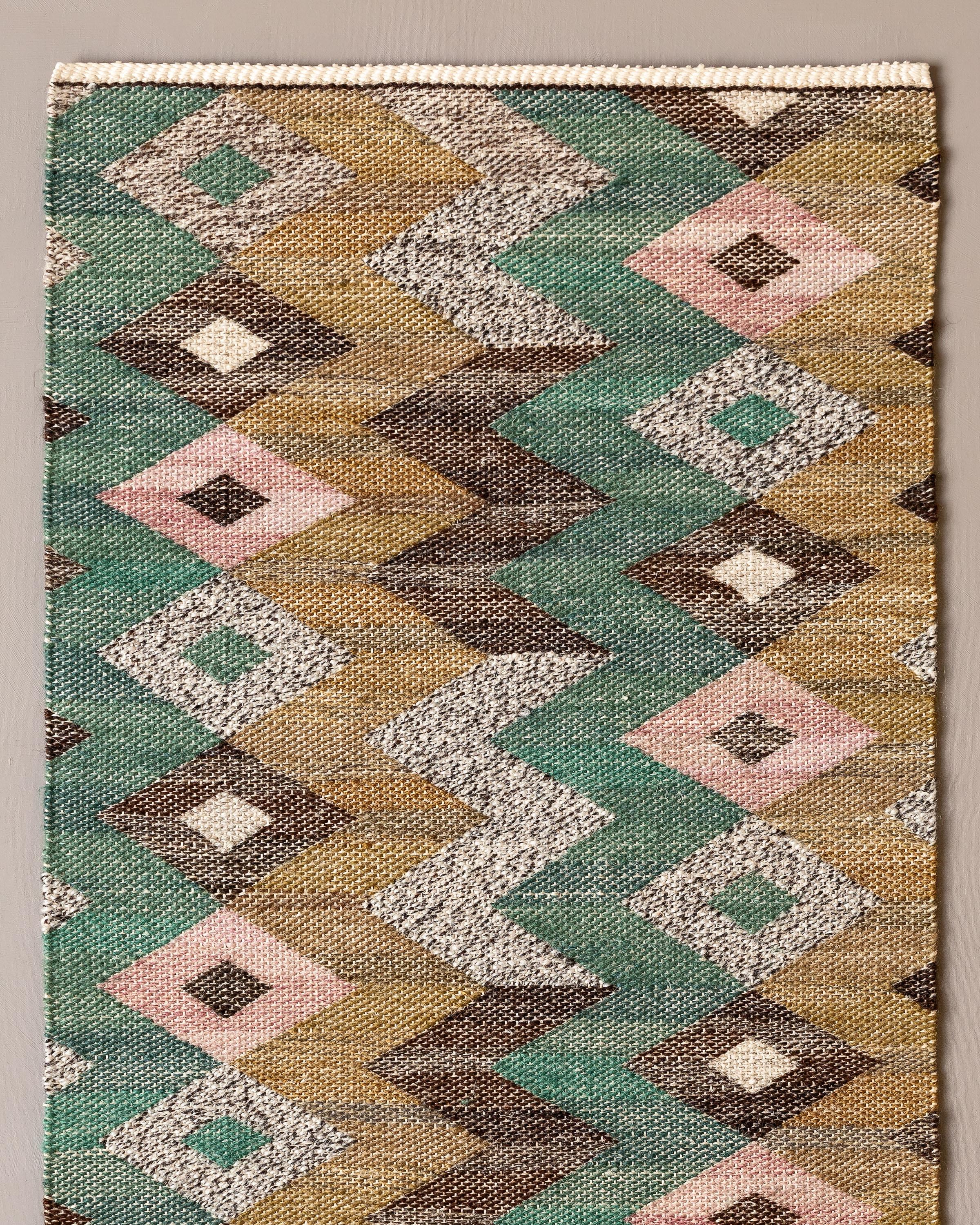 Handwoven tapestry with geometric pattern, designed by Märta Måås-Fjetterström in 1928. 

Woven in wool and hand spun linen on a linen warp by artisan weaver Märta Paulsson in 1996 at the Märta Måås-Fjetterström studio in Båstad, Sweden. 

The