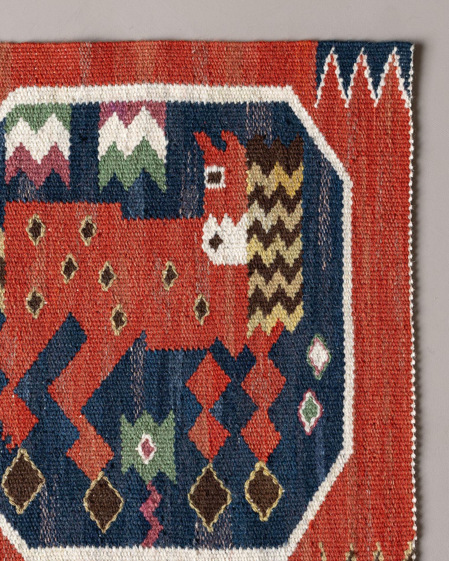 Handwoven tapestry in wool with motif of a red horse, looking back or maybe curious, designed by Märta Måås-Fjetterström in 1930. 

Several horses with different poses appears in the collection of red horses by MMF. They are details from the large