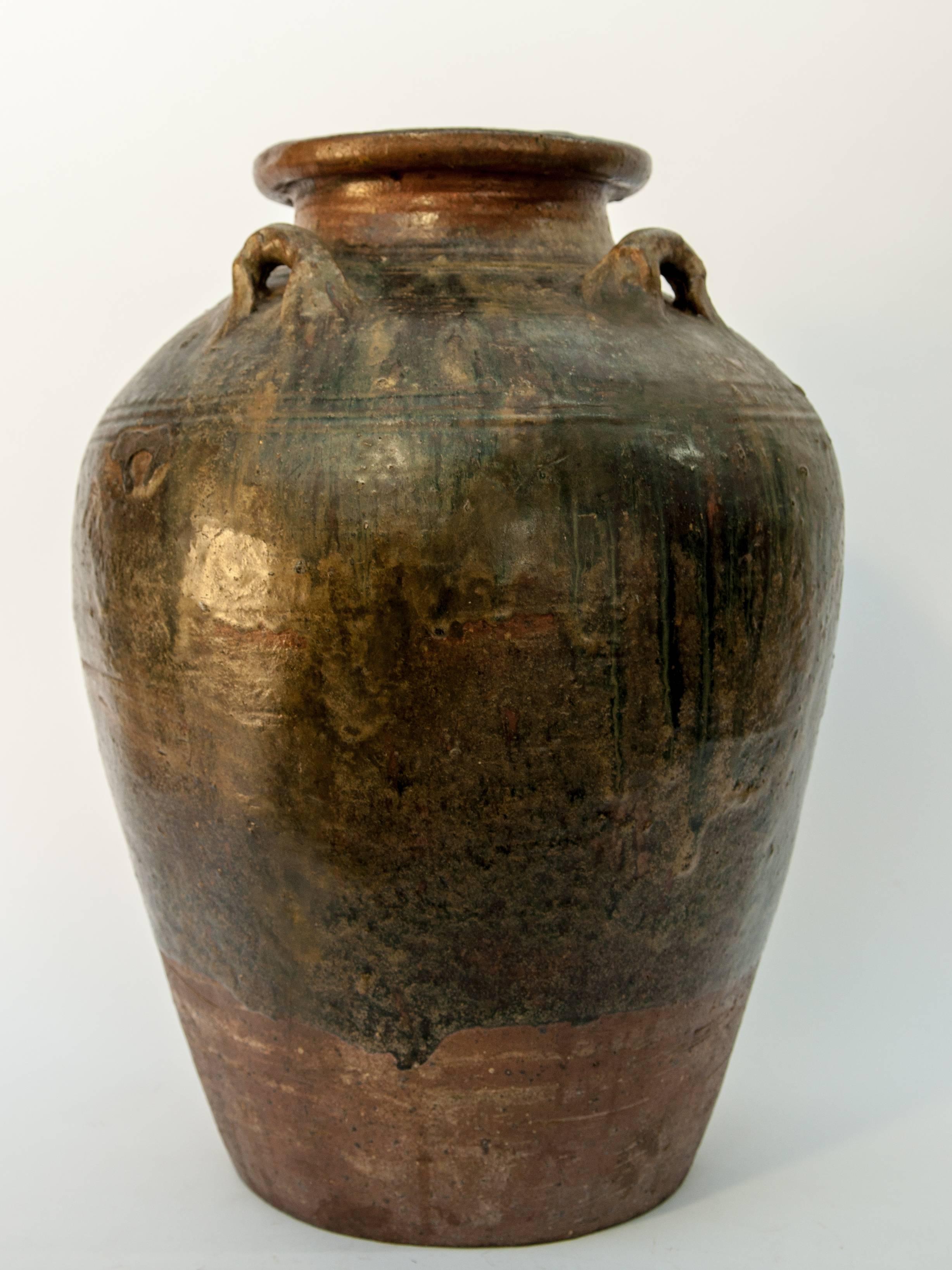 Martaban ware stoneware storage jar, running glaze, Ming dynasty, found in Laos.
This storage jar, brown with a multicolored running glaze, was recovered in Laos, but most likely manufactured elsewhere, in southern China during the Ming dynasty; or